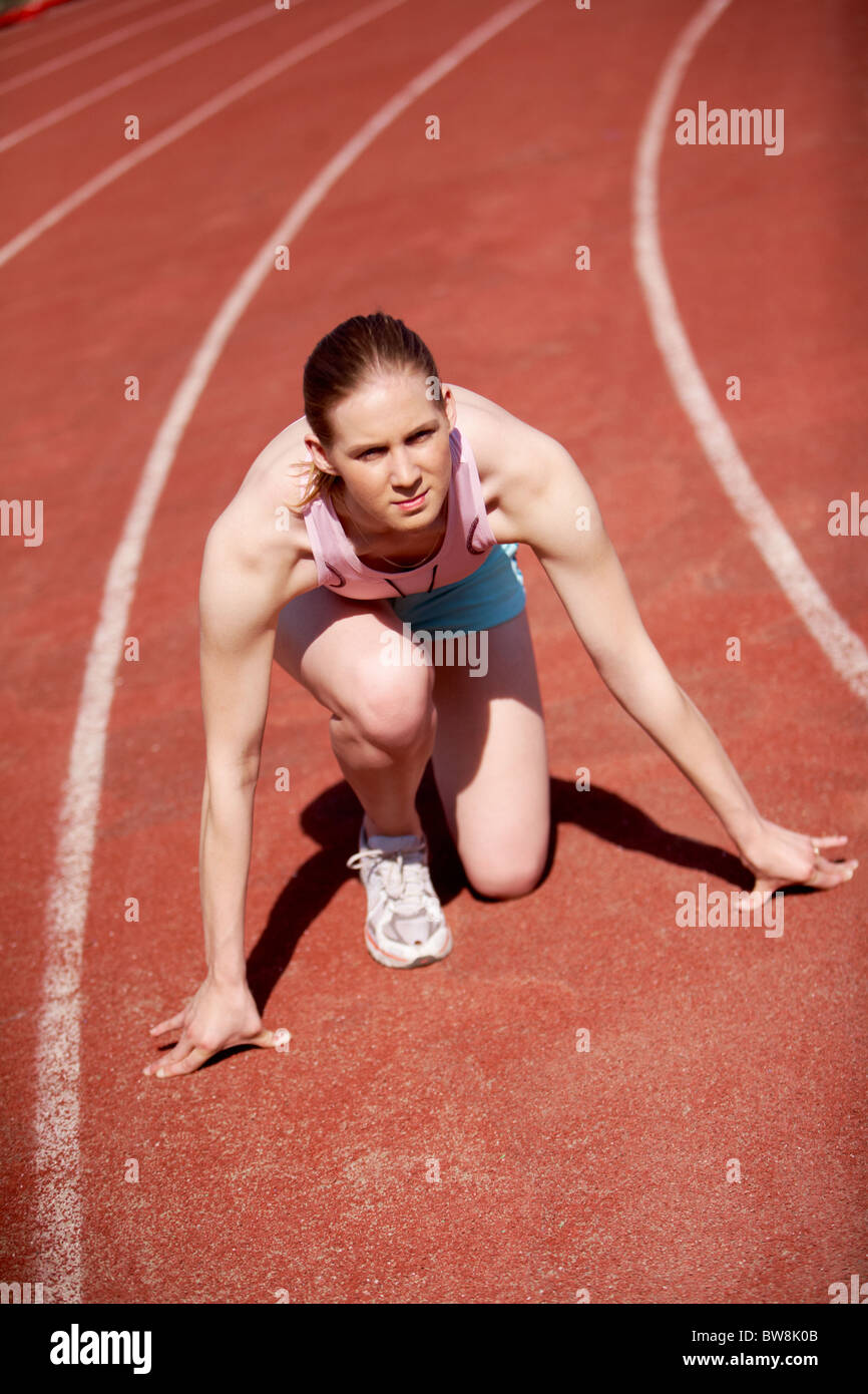 Image of sportive female ready to start running during marathon Stock Photo