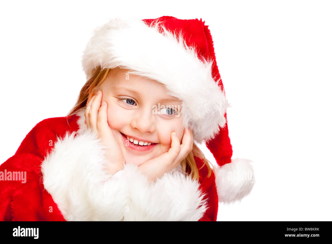 Small girl dressed as Santa Claus smiles happy.  Isolated on white background. Stock Photo