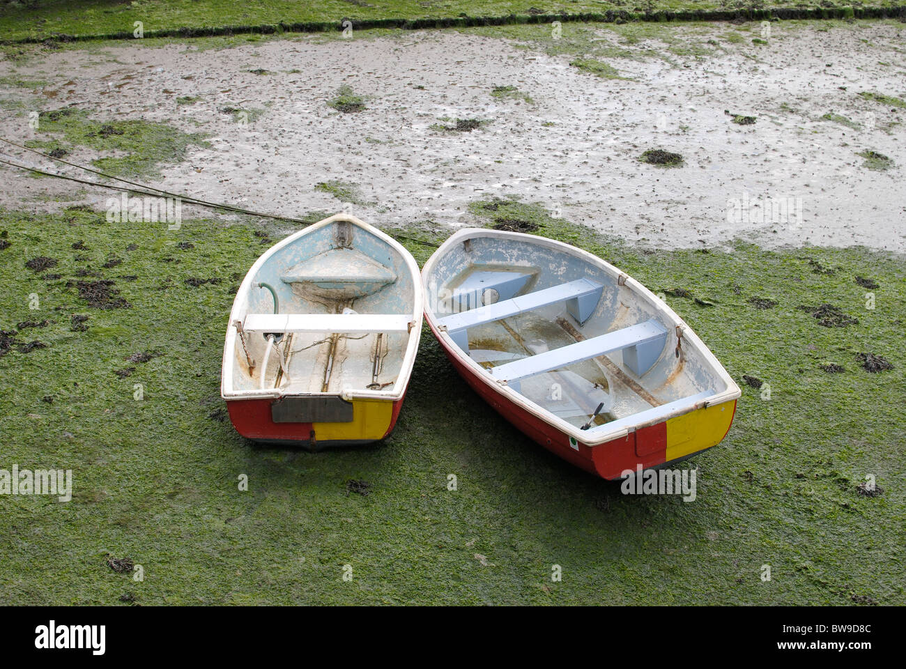 Two rowing boats beached at Dell Quay. Chichester Harbour. West Sussex. England. Low Tide. Stock Photo