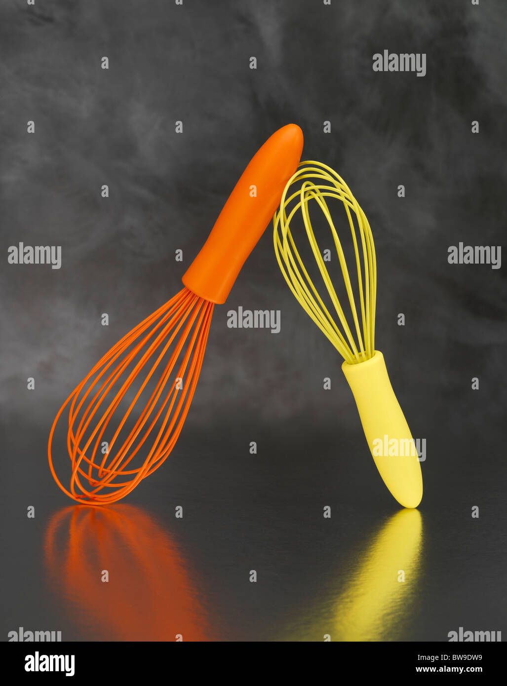 https://c8.alamy.com/comp/BW9DW9/an-orange-and-a-yellow-egg-whisk-on-a-grey-background-BW9DW9.jpg