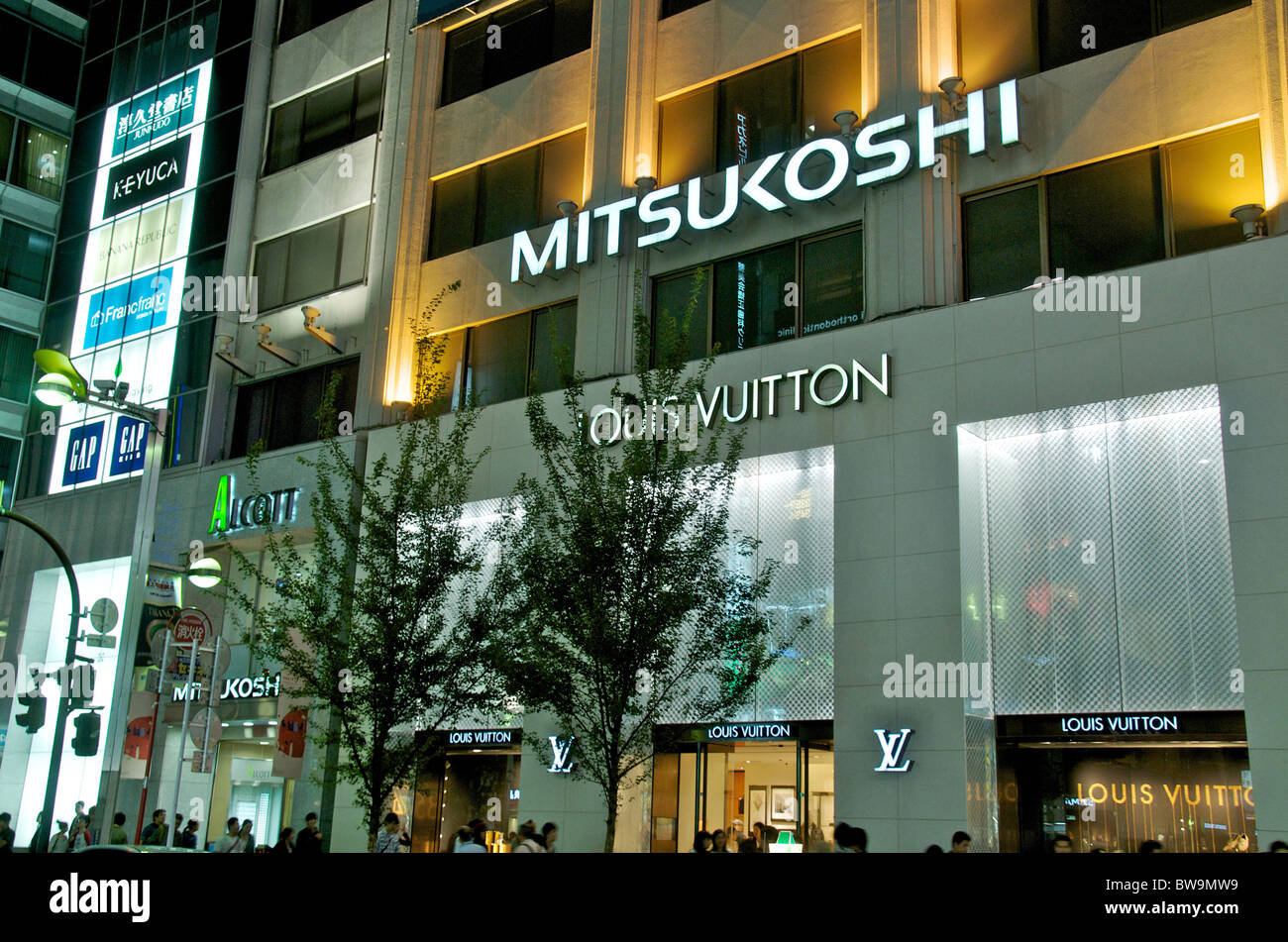 street scene by night, Louis Vuitton store, Shinjuku, Tokyo, Japan Stock Photo