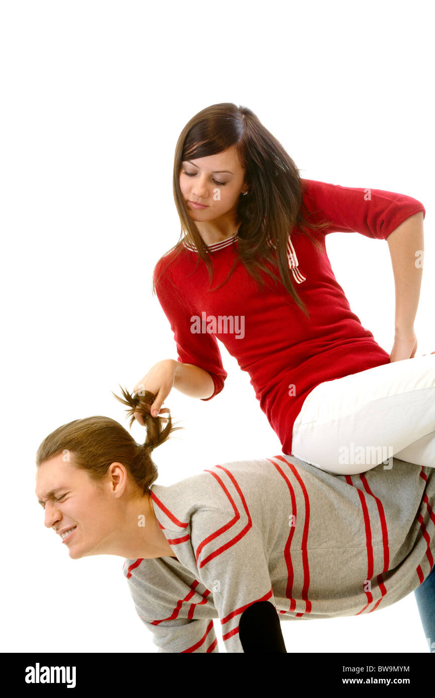 Portrait of attractive young girl pulling her boyfriend hair while sitting  on his back Stock Photo - Alamy