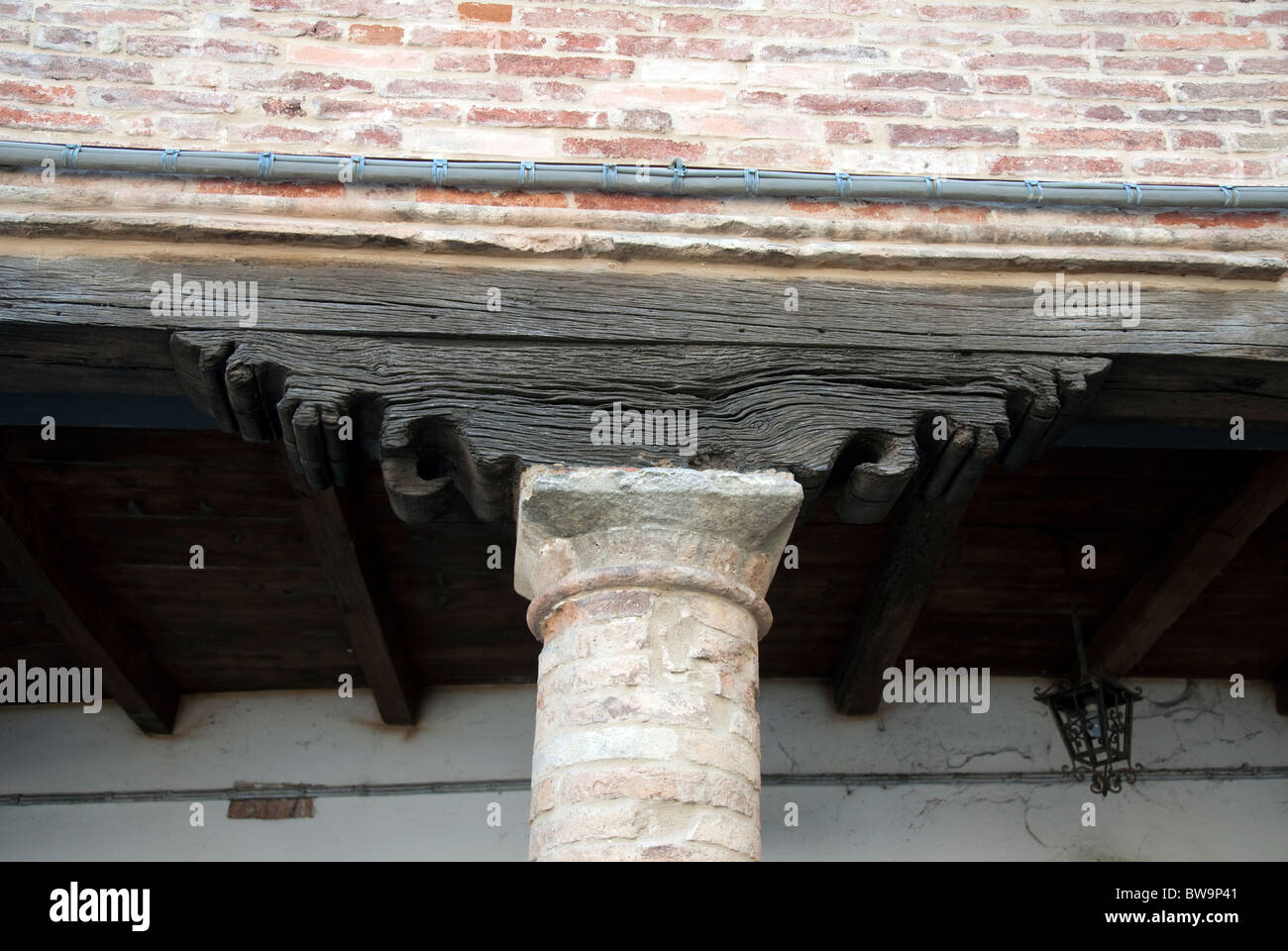 Carved wooden beam and capital of a building in Le Marche, Italy Stock Photo