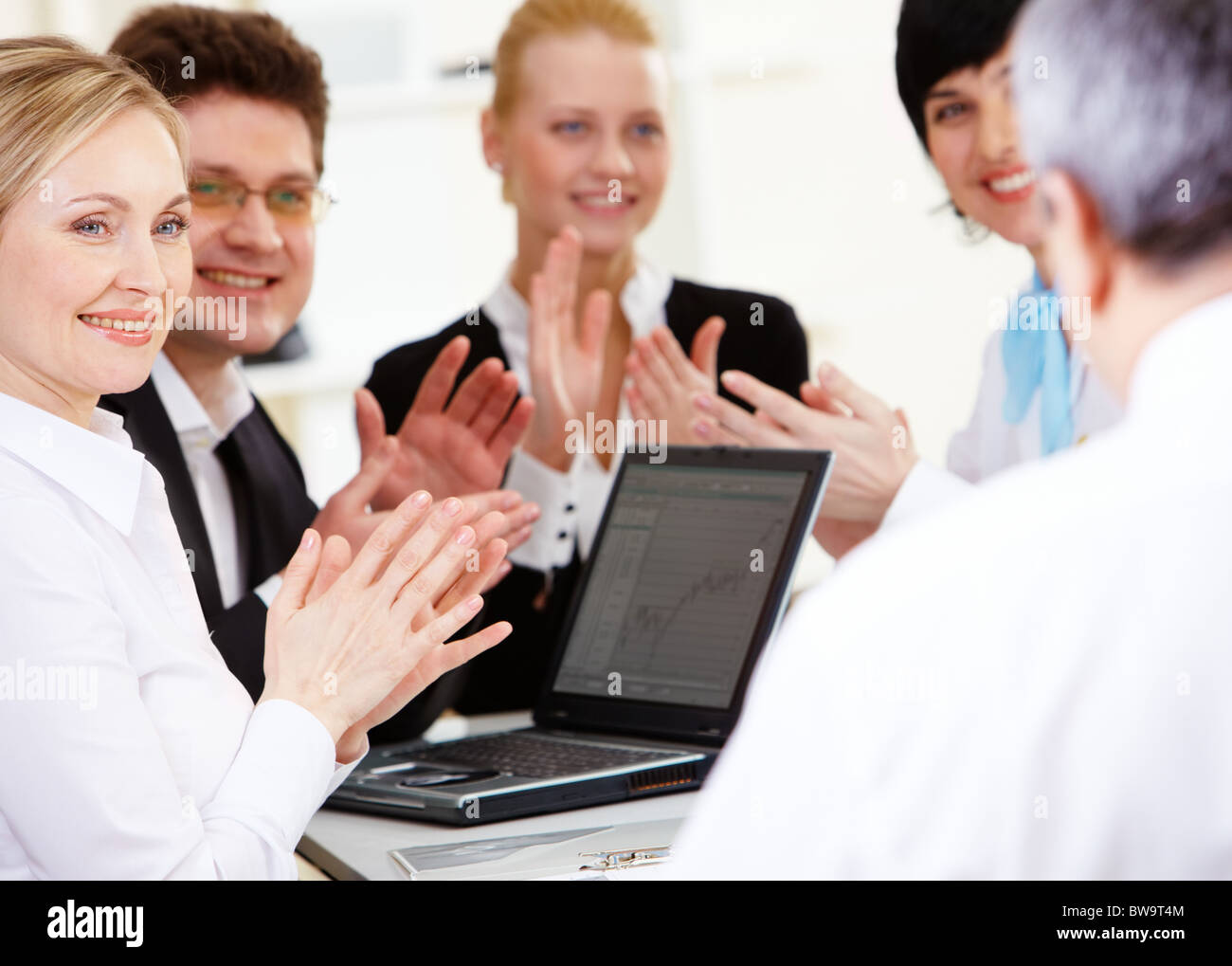 Photo of happy business partners applauding to their senior leader after making report Stock Photo