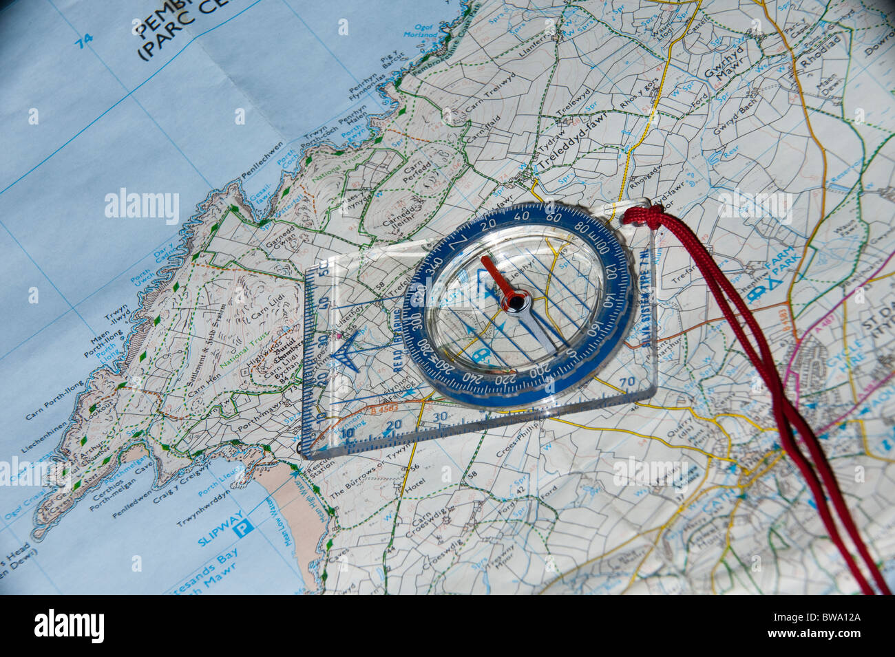 A Map and Compass being used for route planning Stock Photo Alamy