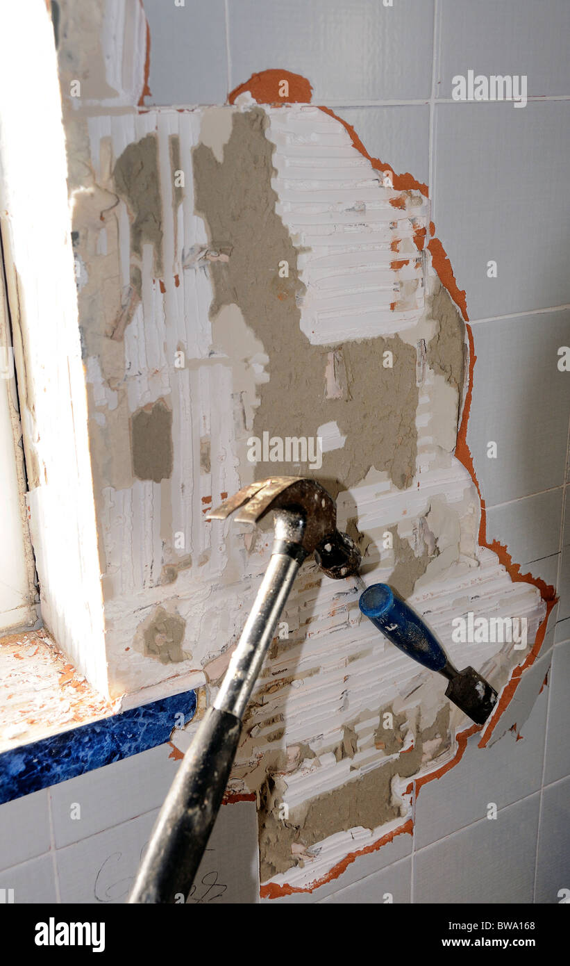 knocking old tiles off wall Stock Photo Alamy