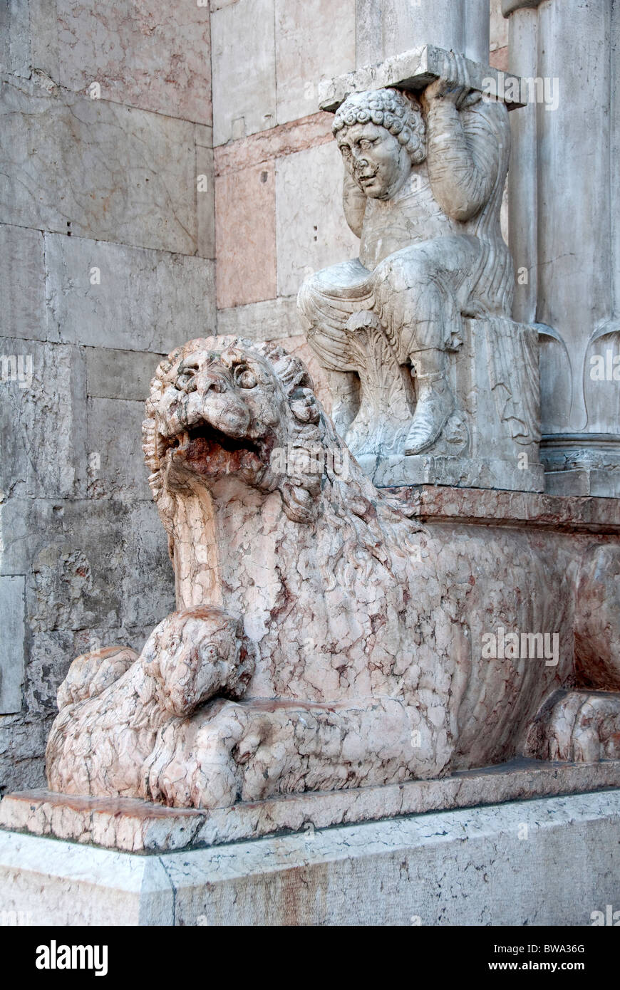 Lion and figure on the front of Ferrara Cathedral left side of portal with BWA3HY Stock Photo