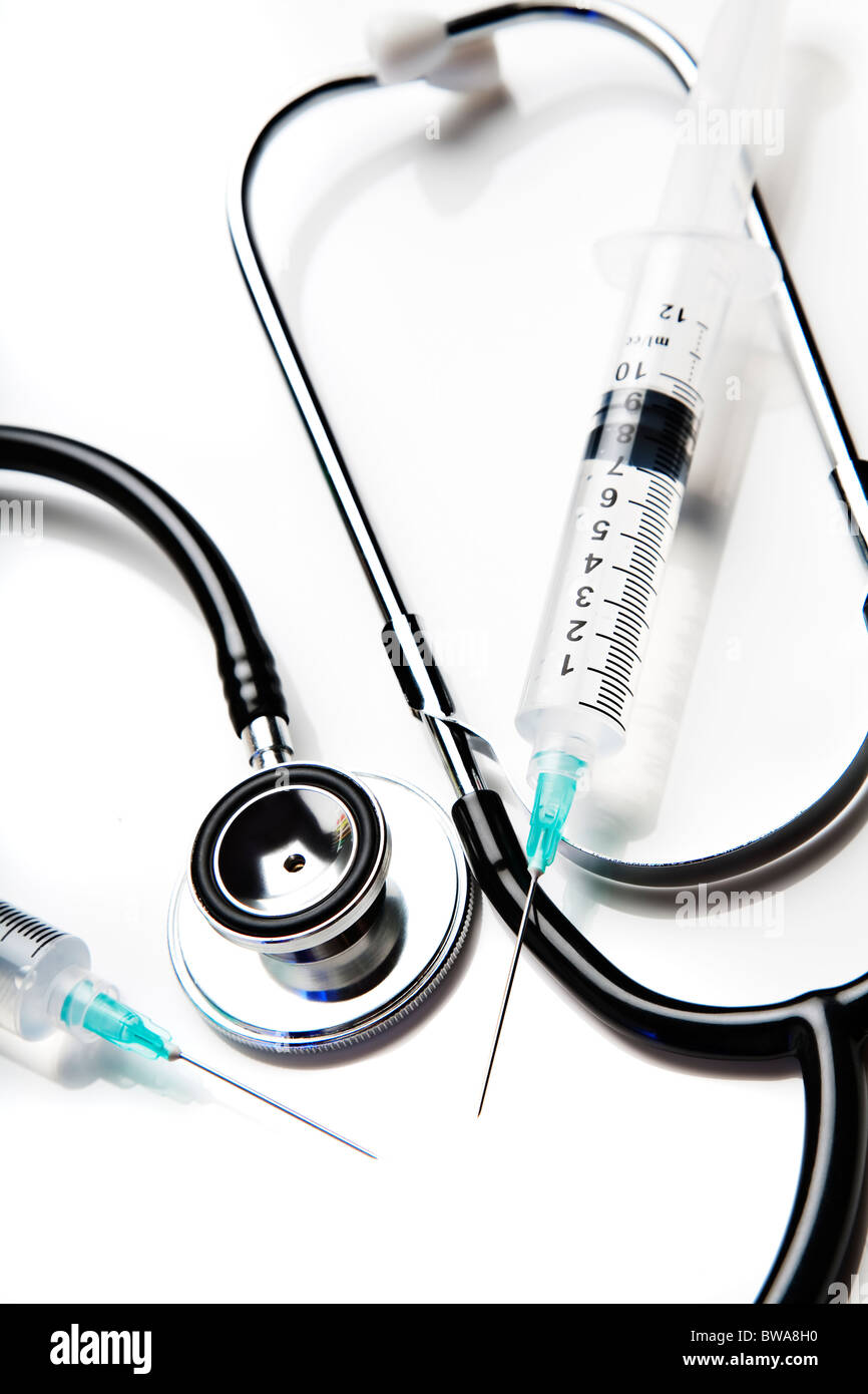 Stethoscope and syringes on white Stock Photo
