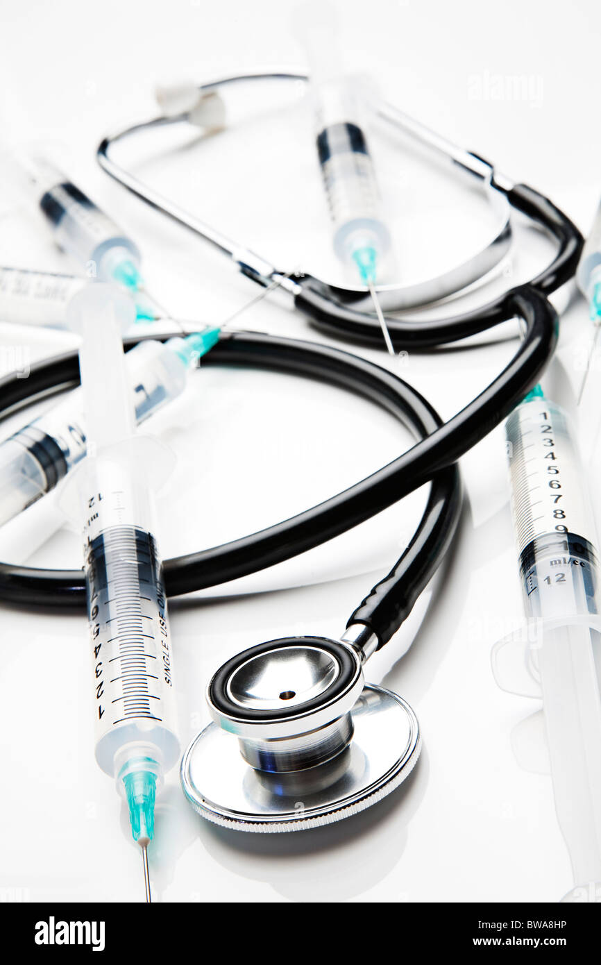 Stethoscope and syringes on white Stock Photo - Alamy