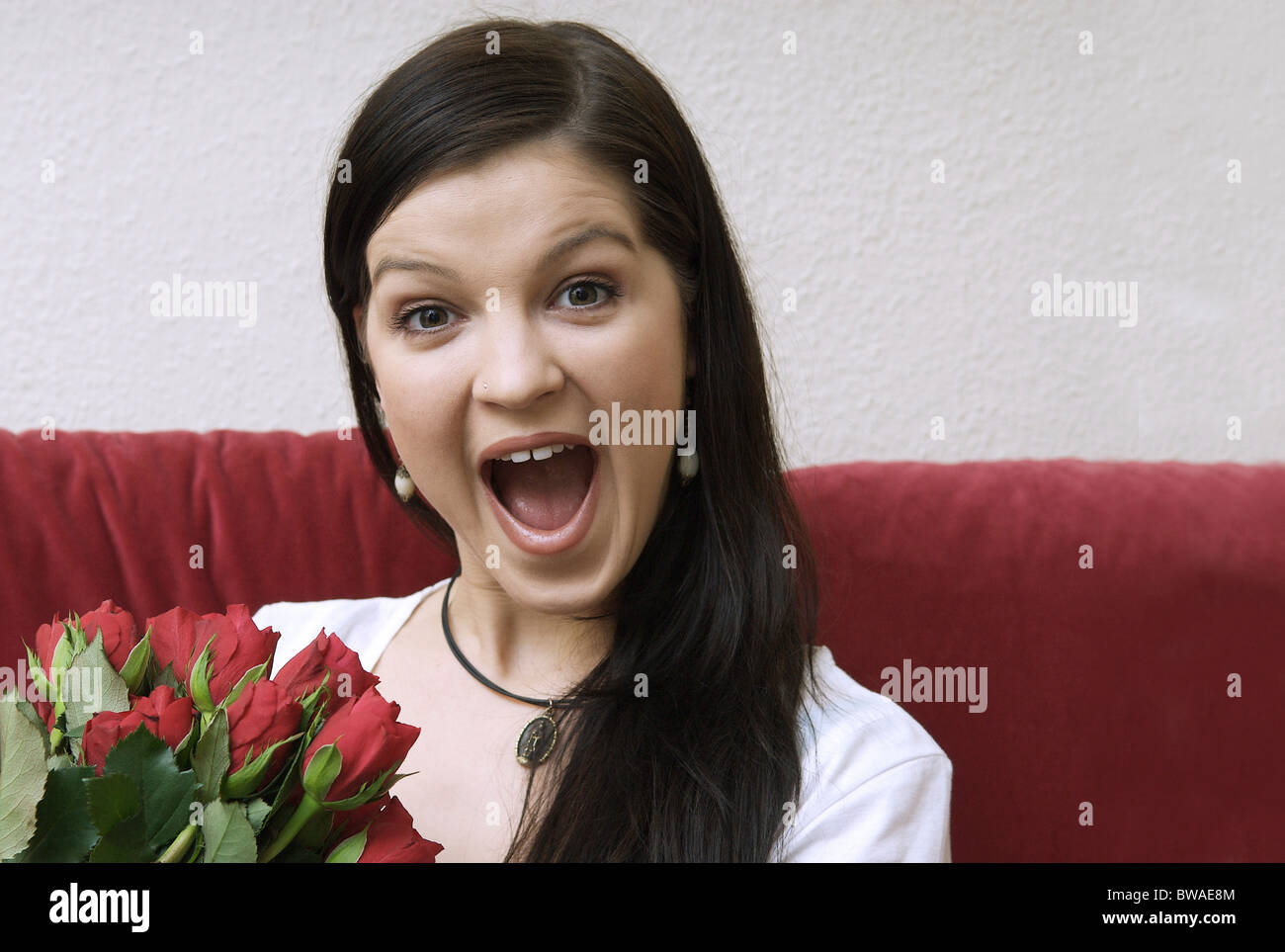 Young woman with a bouquet of red roses Stock Photo - Alamy