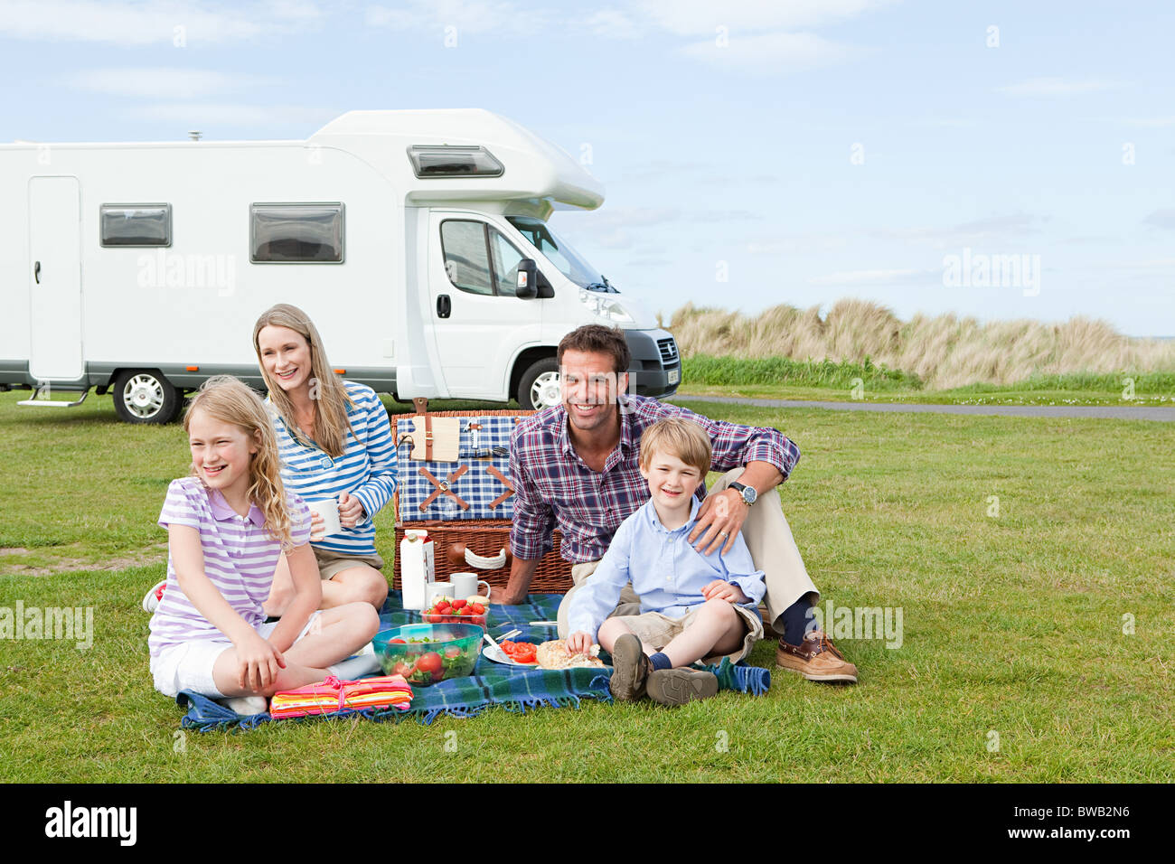 Family having picnic by caravan Stock Photo