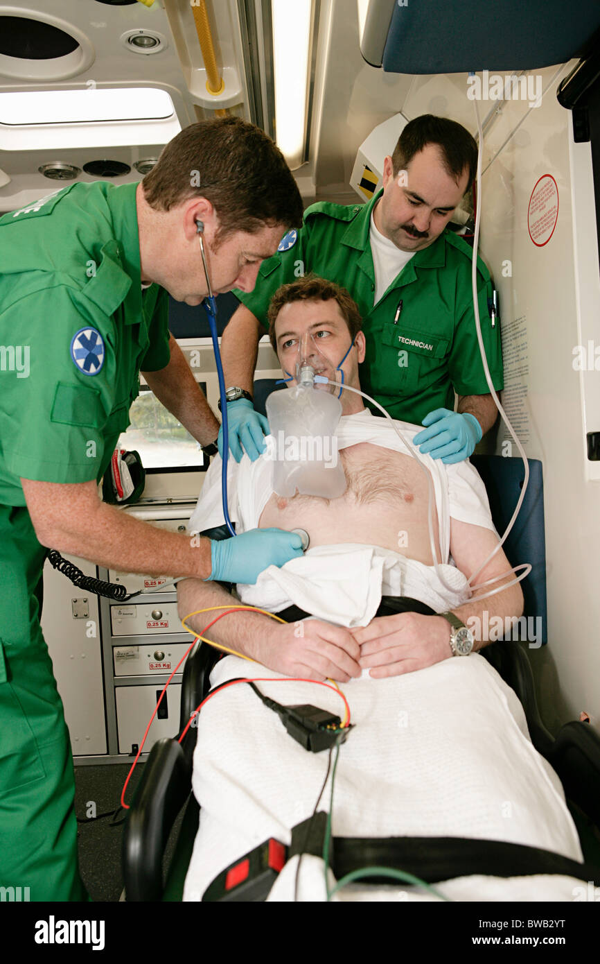 Ambulance technicians caring for patient Stock Photo
