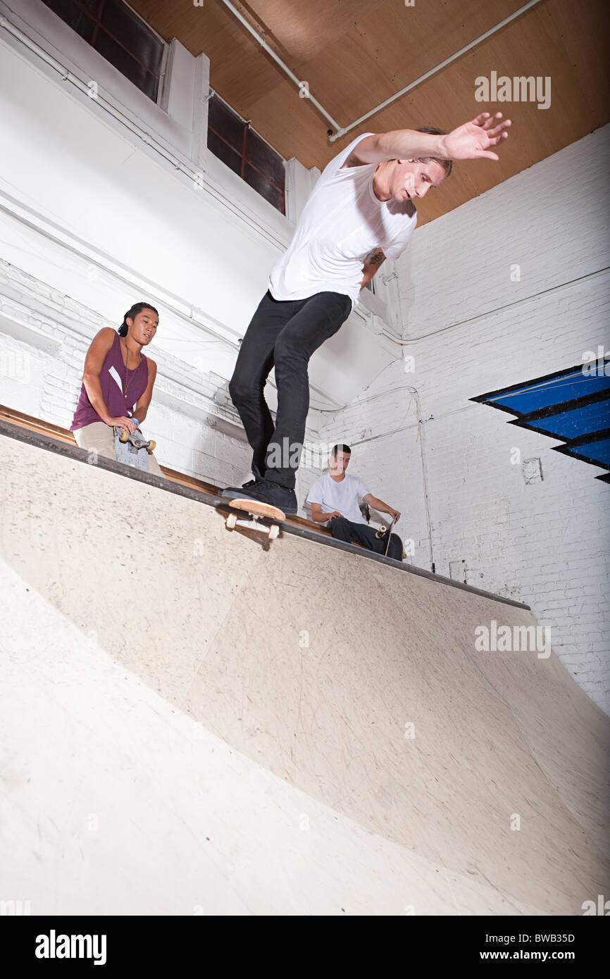 Skateboarder on ramp at skate park Stock Photo - Alamy