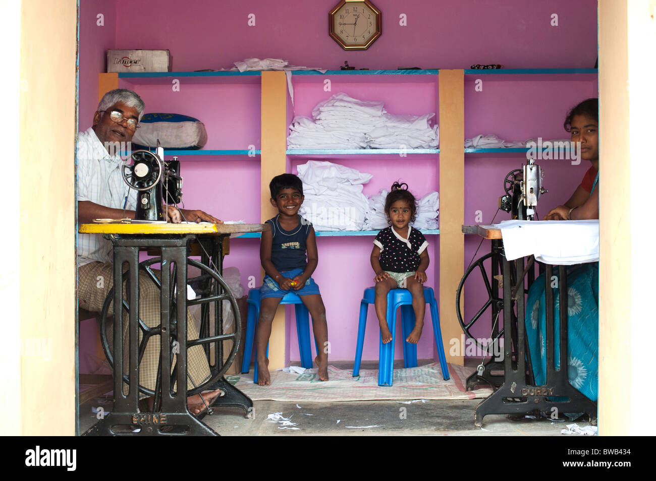 India family in their sewing shop in a rural indian village. Andhra Pradesh, India Stock Photo