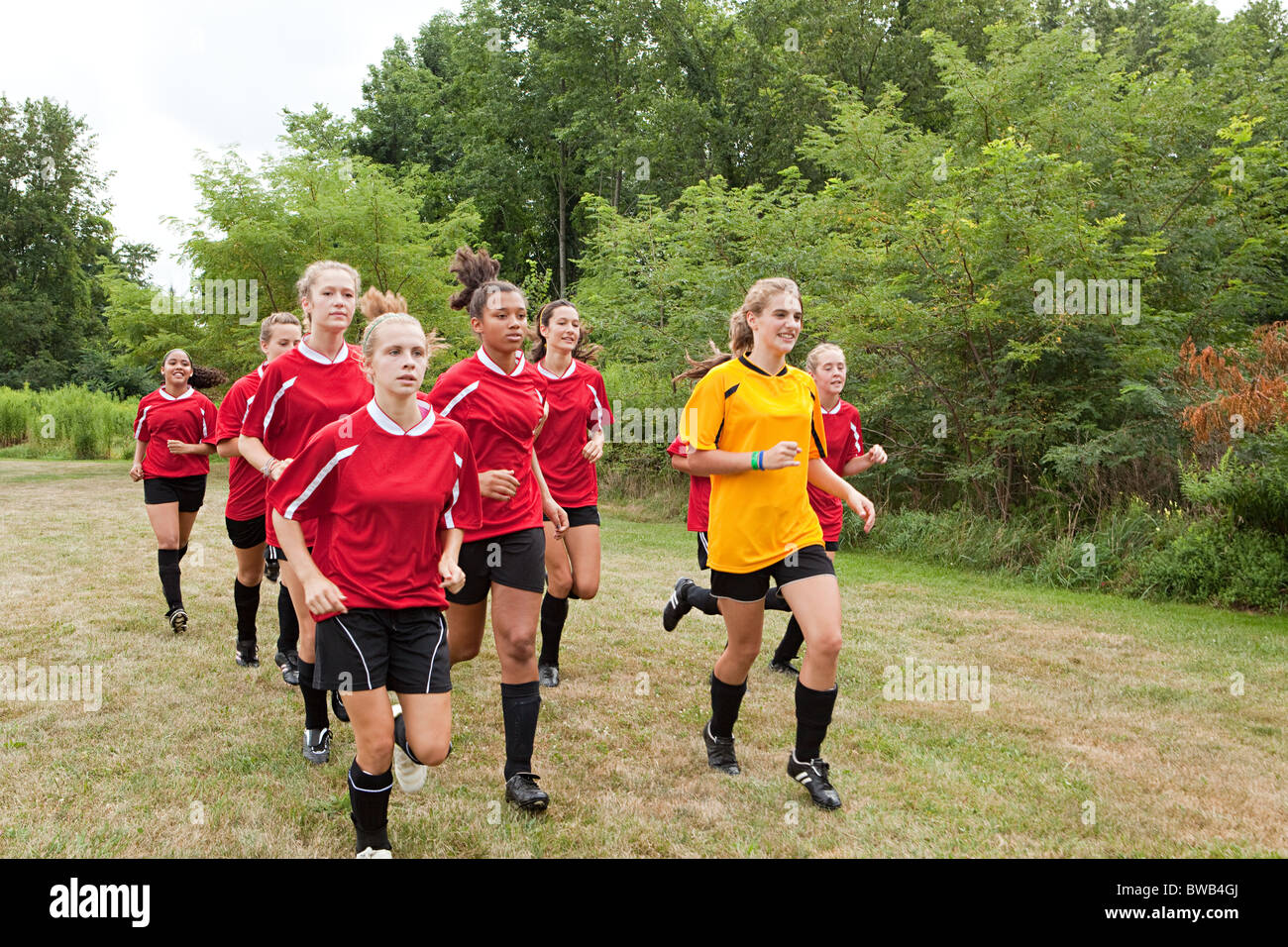 Girl soccer players running Stock Photo