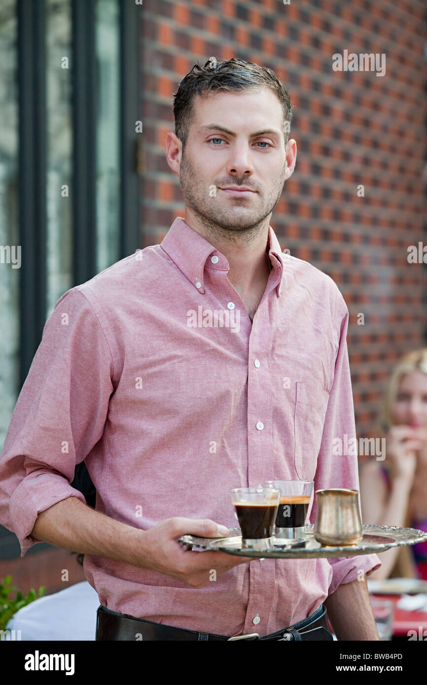 Waiter with espresso coffees Stock Photo