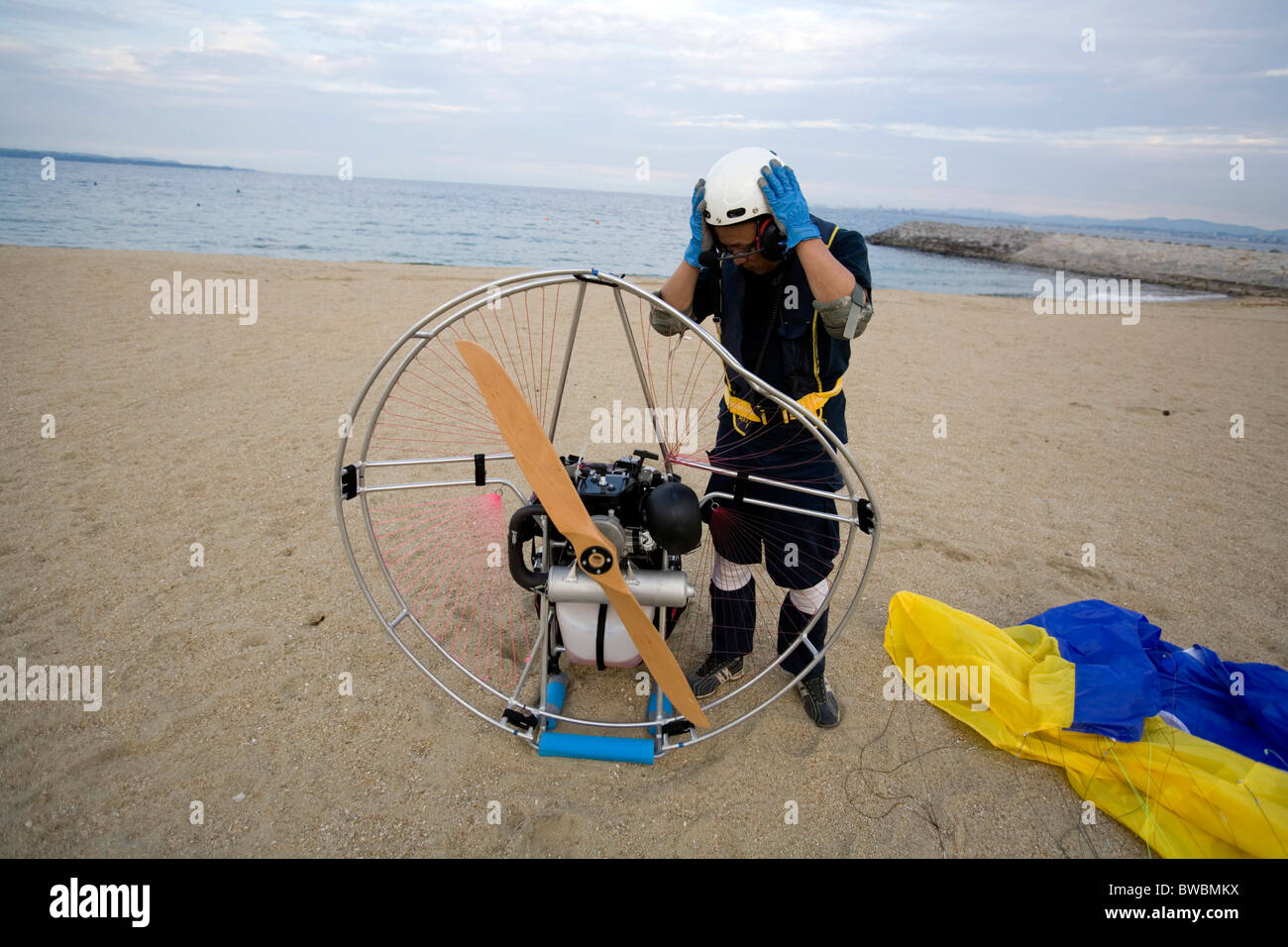Man checking the conditions of his flying vehicle after a crush, Beppu, Japan. Stock Photo