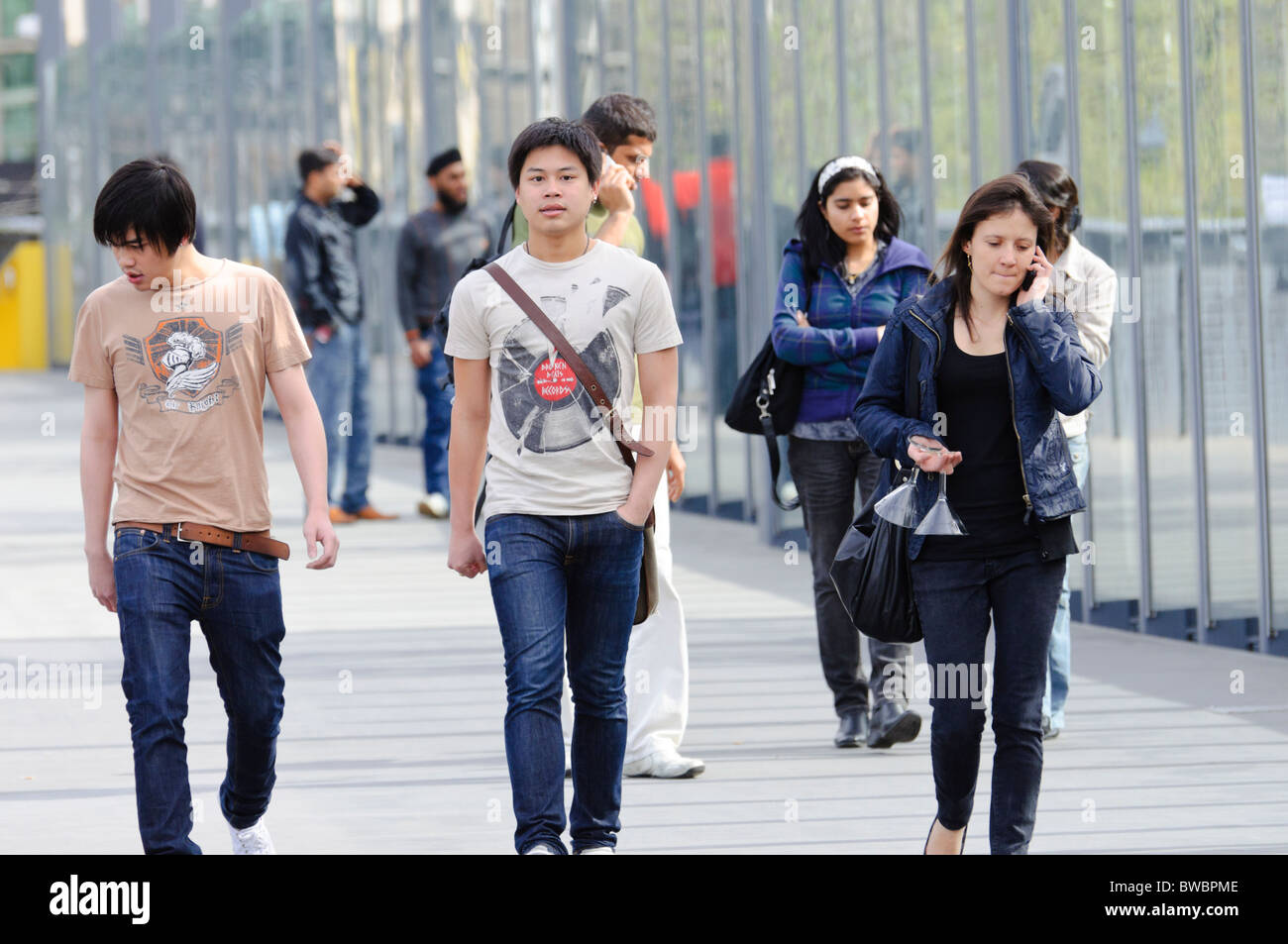 Young ethnic people walking.  International students, migrants, and/or Asian-Australians. Stock Photo