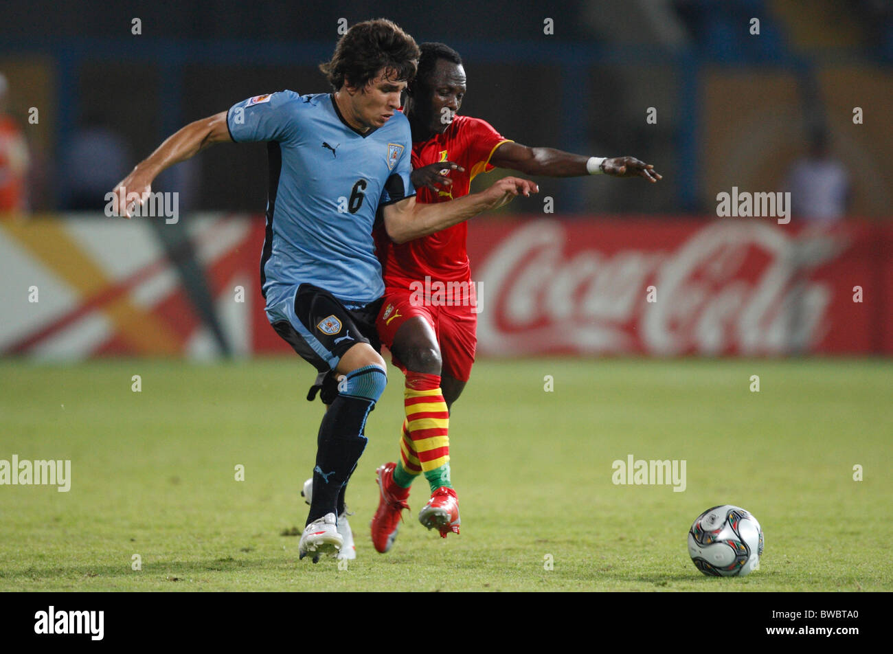 Leandro Cabrera of Uruguay (l) and Emmanuel Agyemang Badu of Ghana (r) fight for the ball during a 2009 FIFA U20 World Cup match Stock Photo