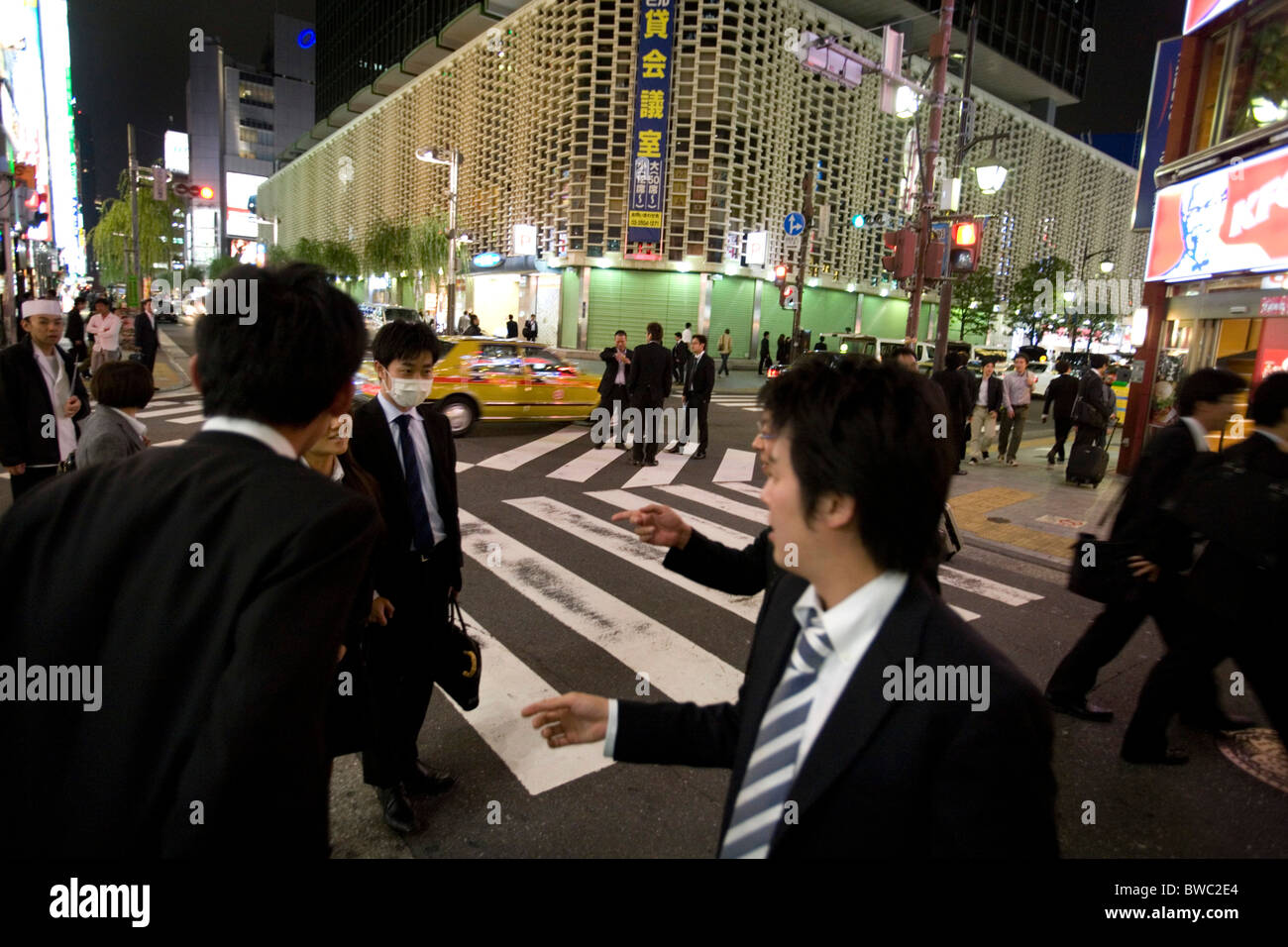 People in the street of Ginza at nighttime, Tokyo, Japan. Stock Photo