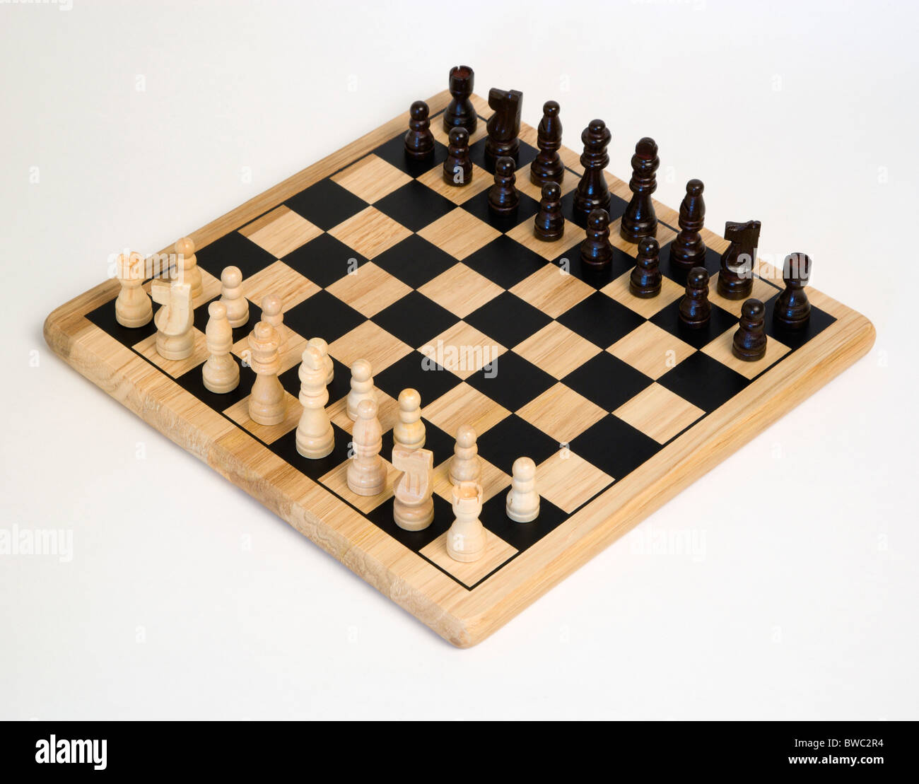 Toys, Games, Board Games, Chess board with pieces laid out for start of game against a white background. Stock Photo