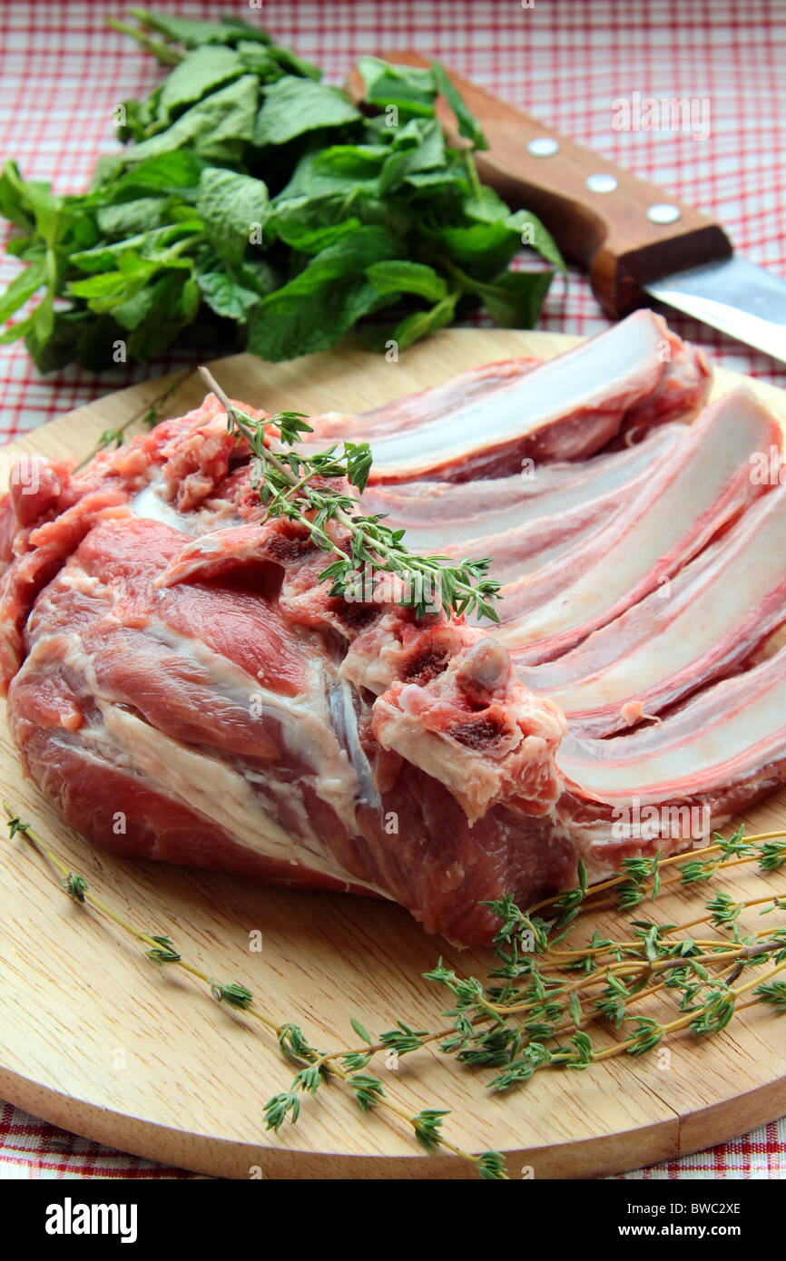 Lamb meat cut into steaks on wooden board Stock Photo Alamy