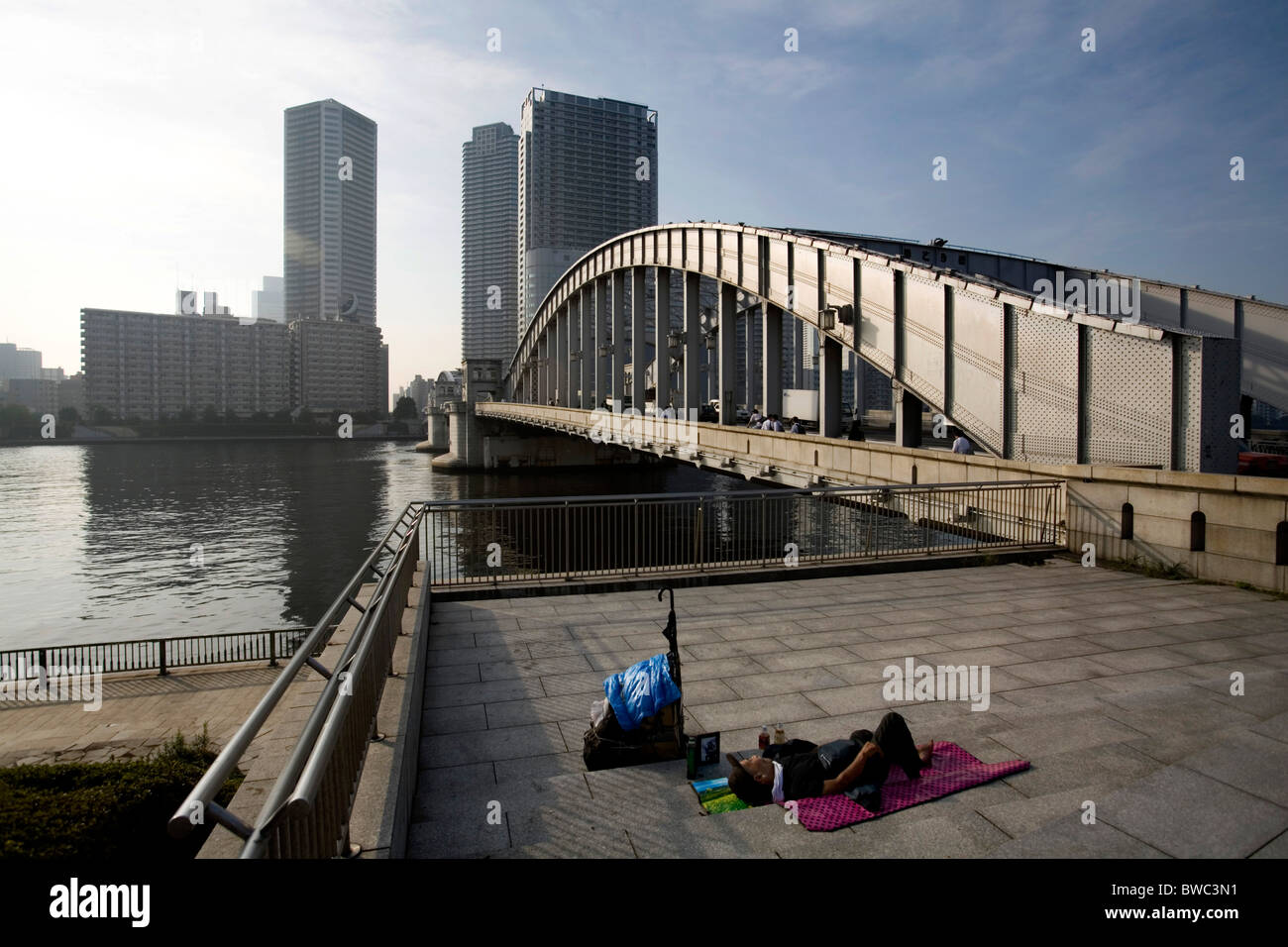 Homeless sleeping on the pavement Harumi Dori bridge near Ginza, Tokyo