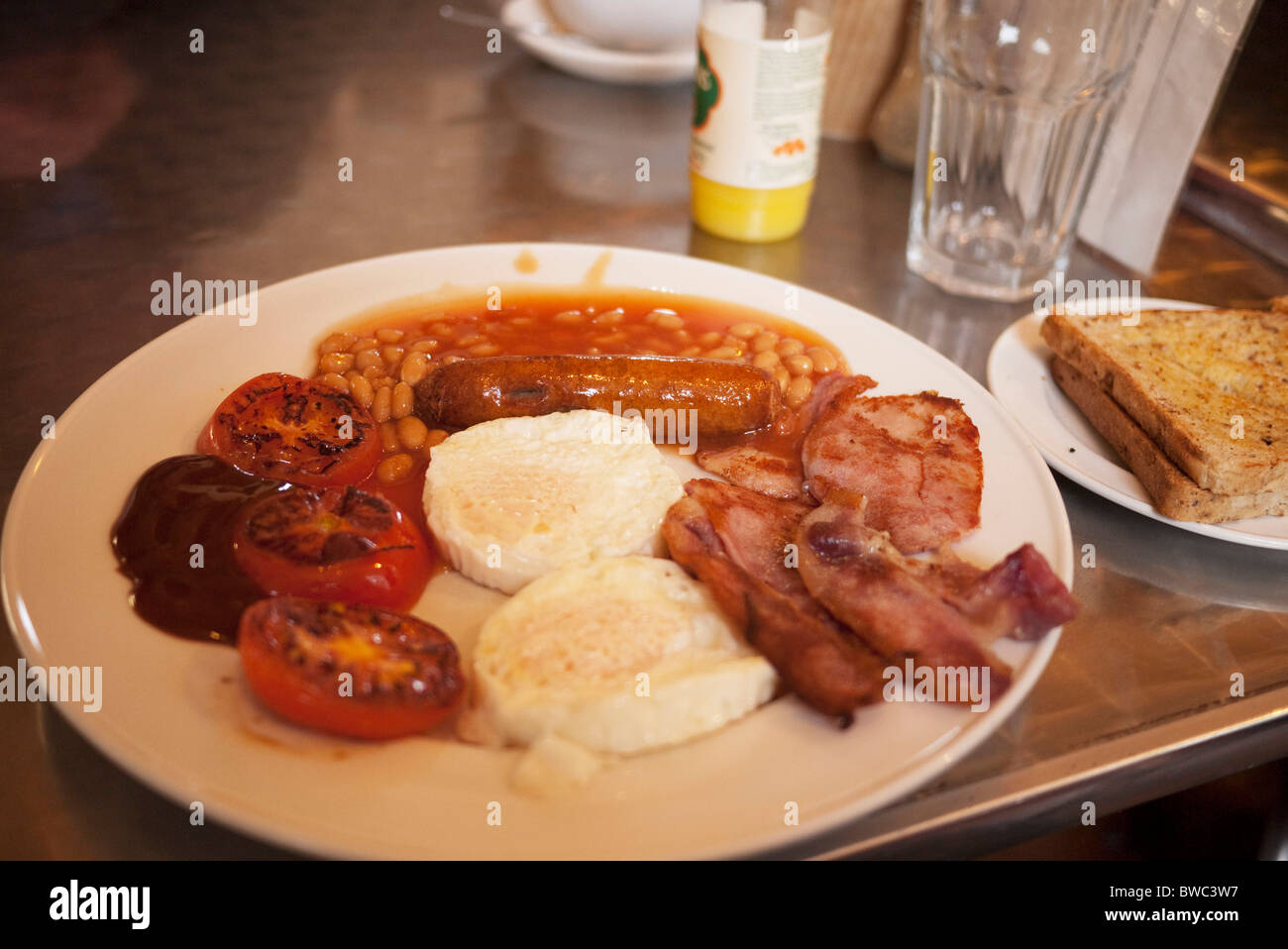 A full English breakfast on a plate in a 'greasy spoon' cafe. Also