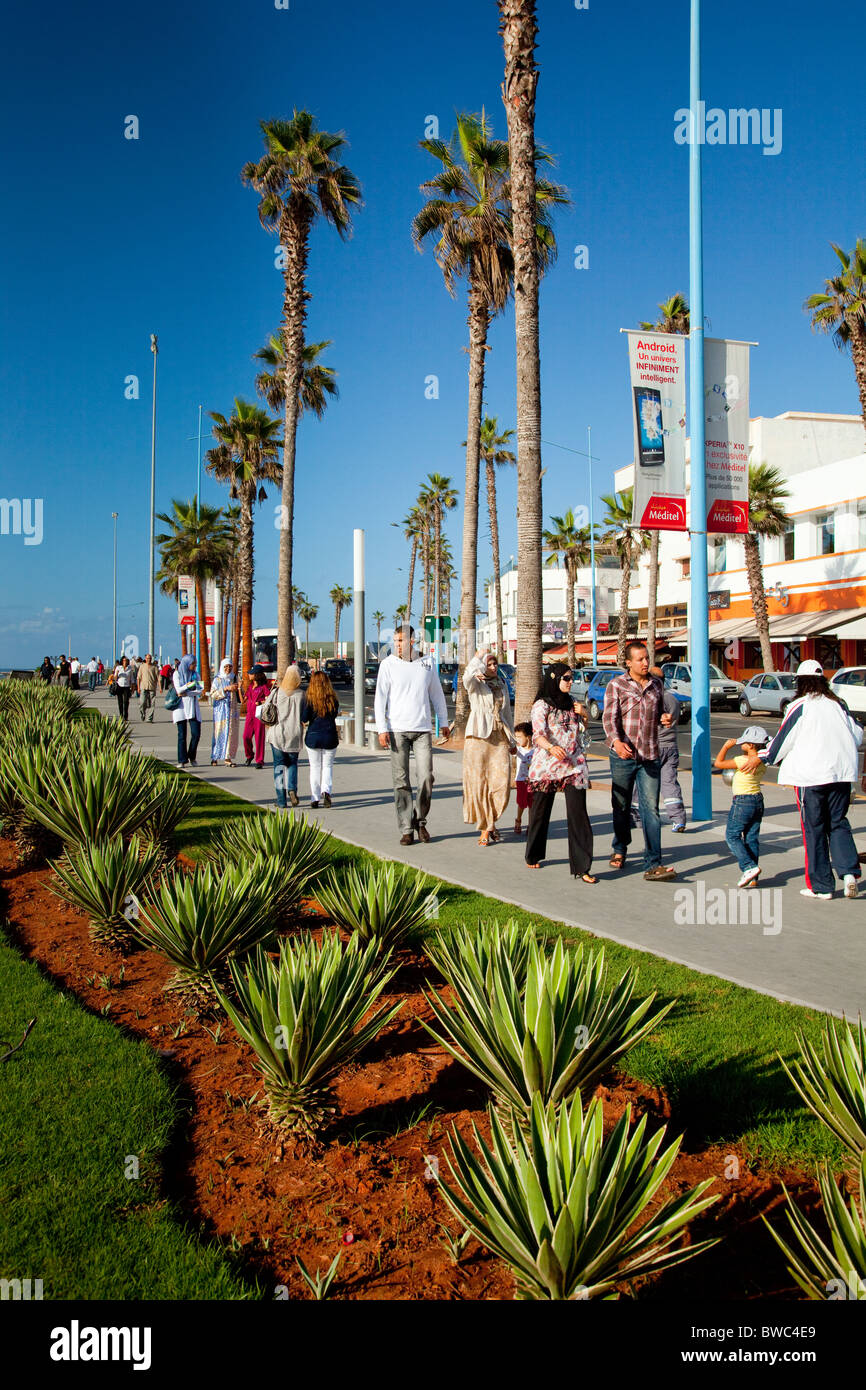Moroccan pedestrians walk along the Corniche promenade in Casablanca, Morocco. Stock Photo