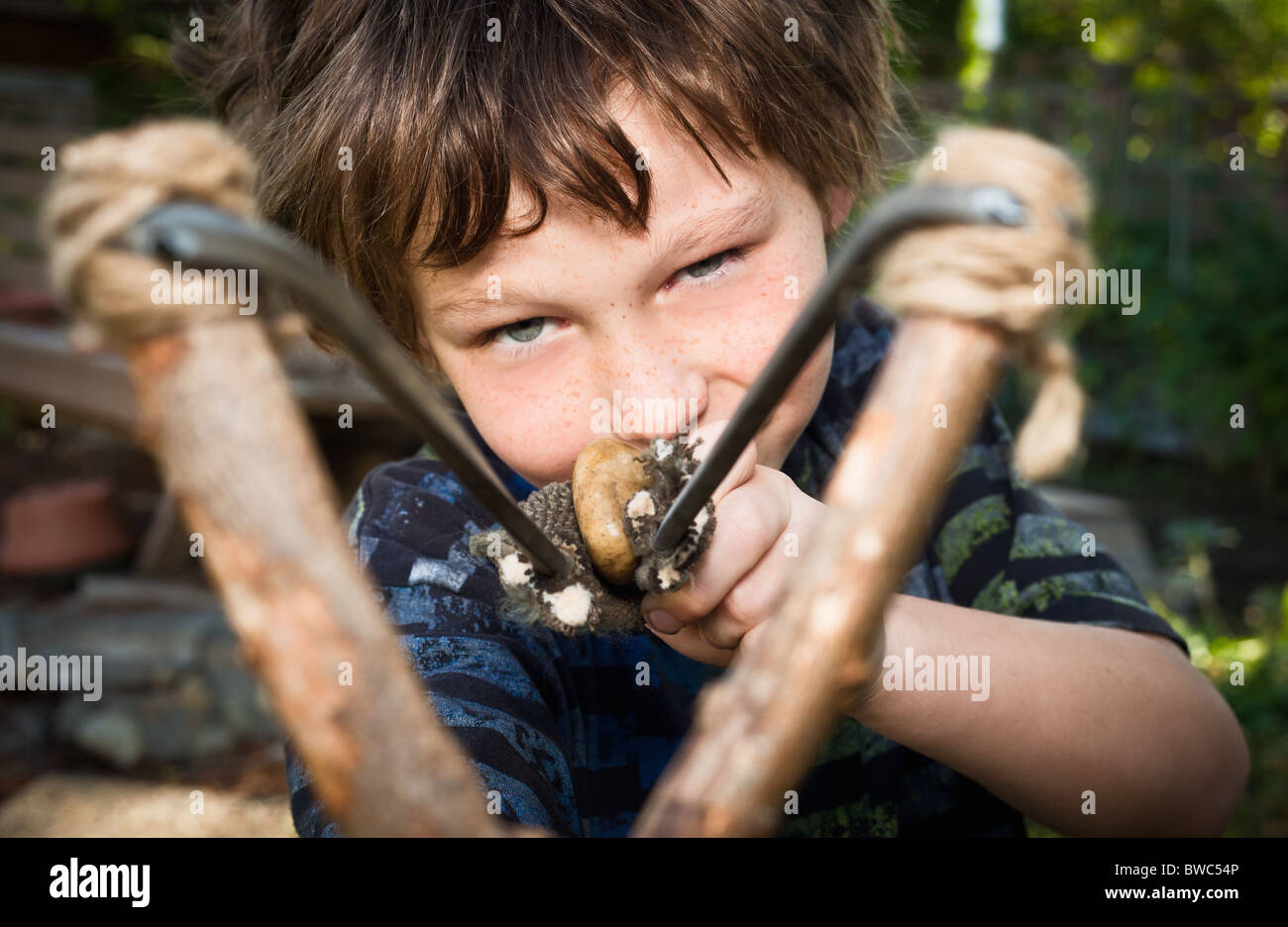 Boy aiming catapult Stock Photo