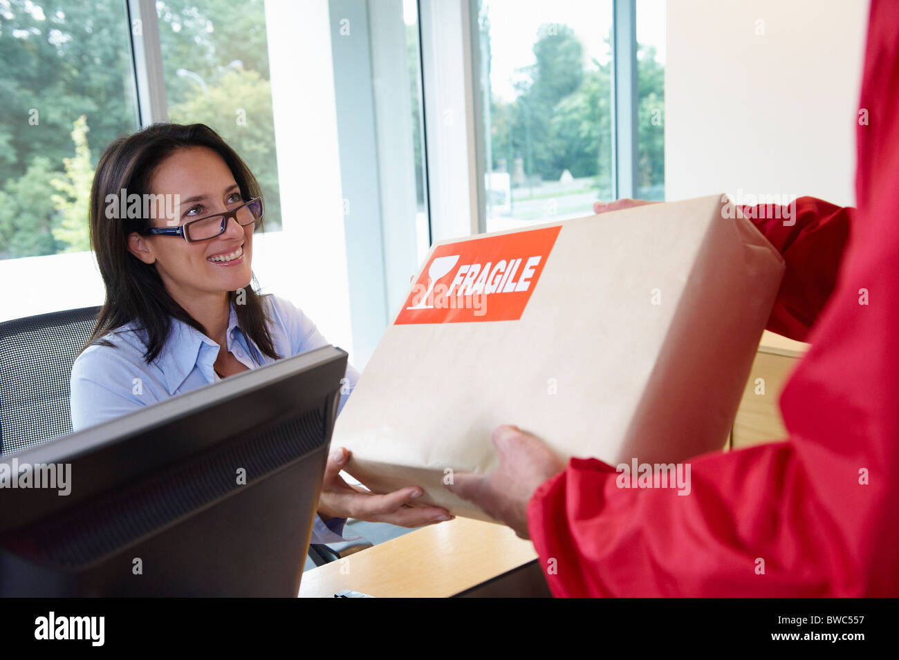 Businesswoman receiving a package Stock Photo