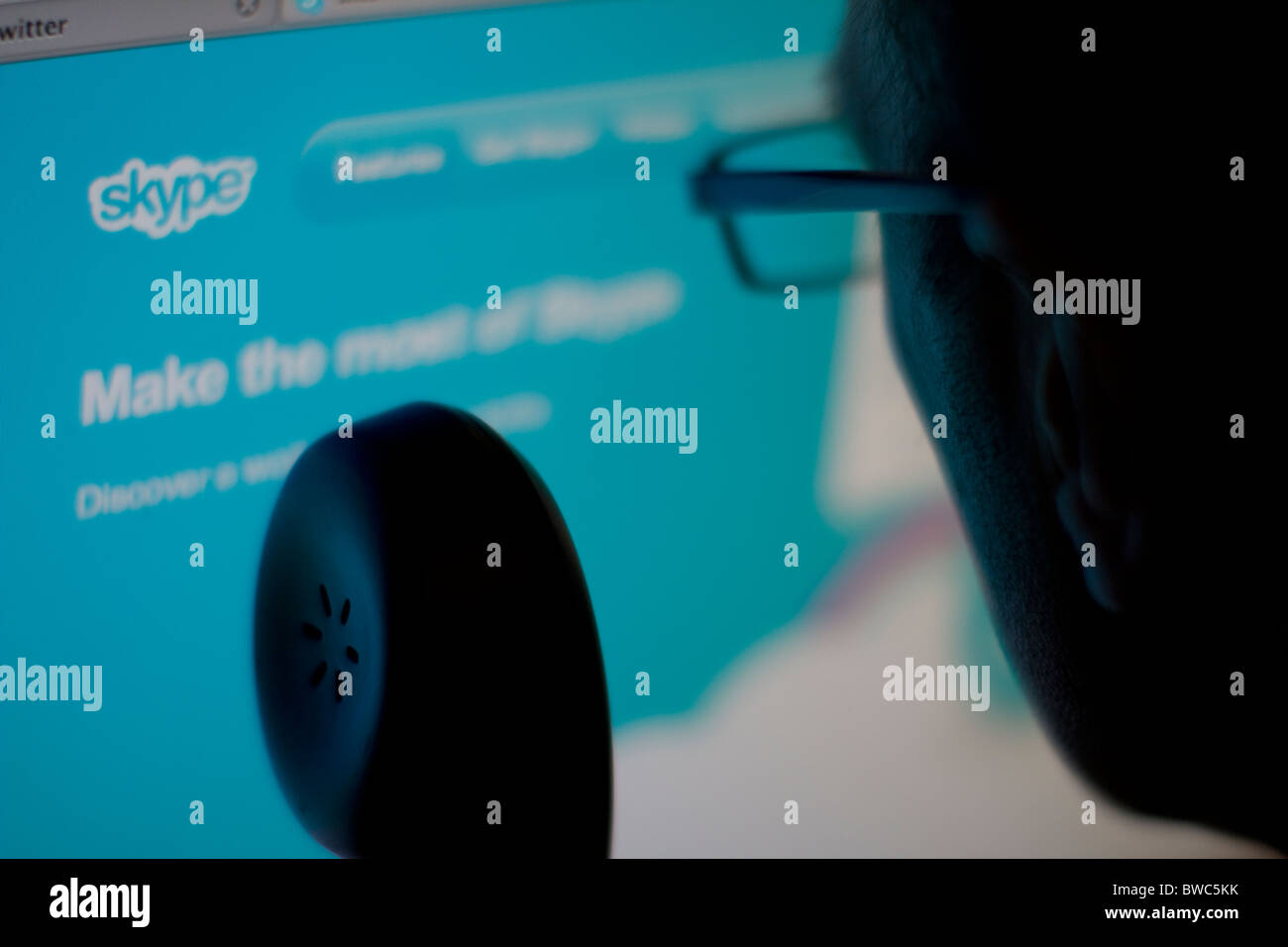 Website of skype internet telecoms company, with man on phone Stock Photo