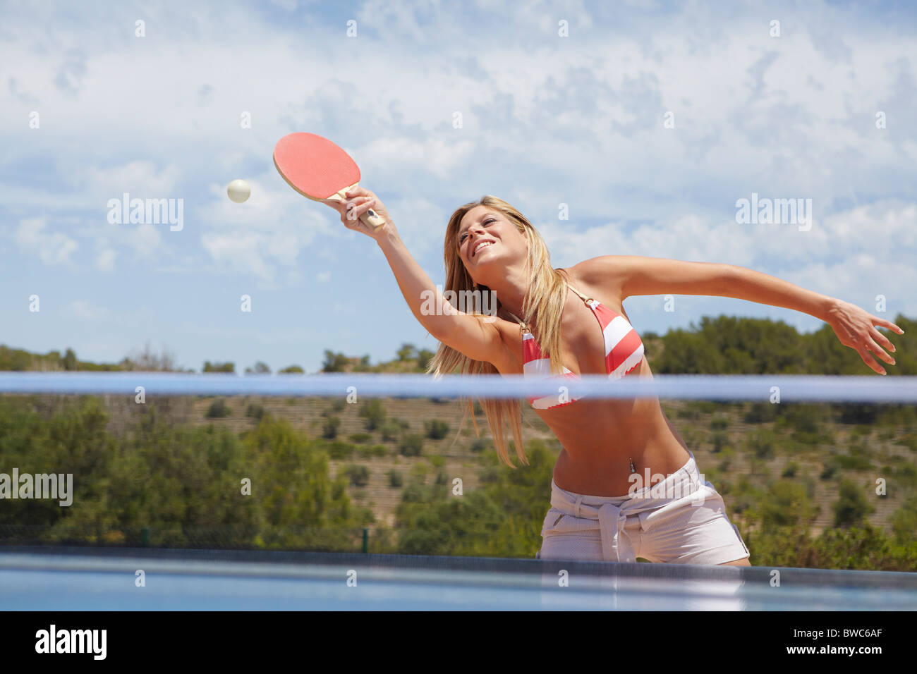 Woman in a game of table tennis outdoors Stock Photo