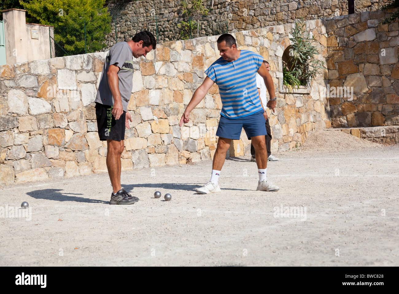 Two players discuss during a game of boules, France. Stock Photo