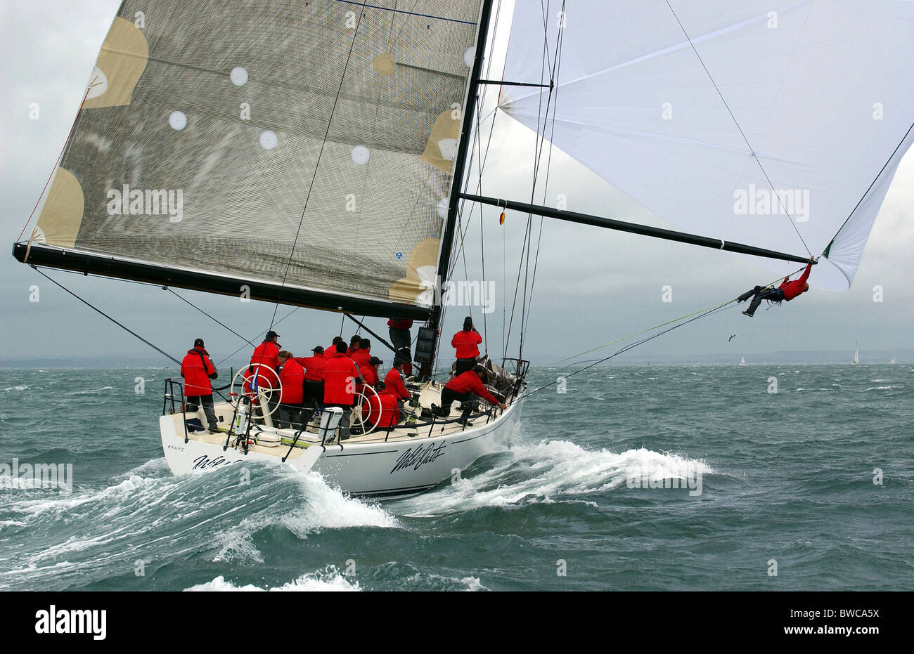 Man swinging from spinnkaer pole on 'Wild Oats'. Admirals Cup, Sydney, Australia, 2003. The Australian team from the Royal Princ Stock Photo