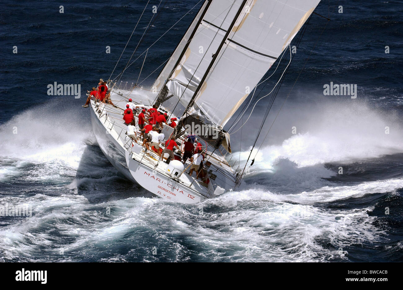 Robert Miller's record-breaking, 140 foot carbon super-maxi, 'Mari Cha IV', thrashes upwind in breezy conditions at Antigua Race Stock Photo