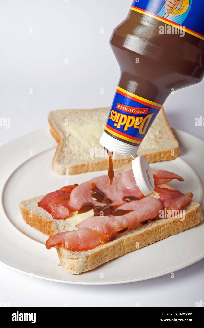 Daddies brown sauce on bacon sandwich Stock Photo Alamy