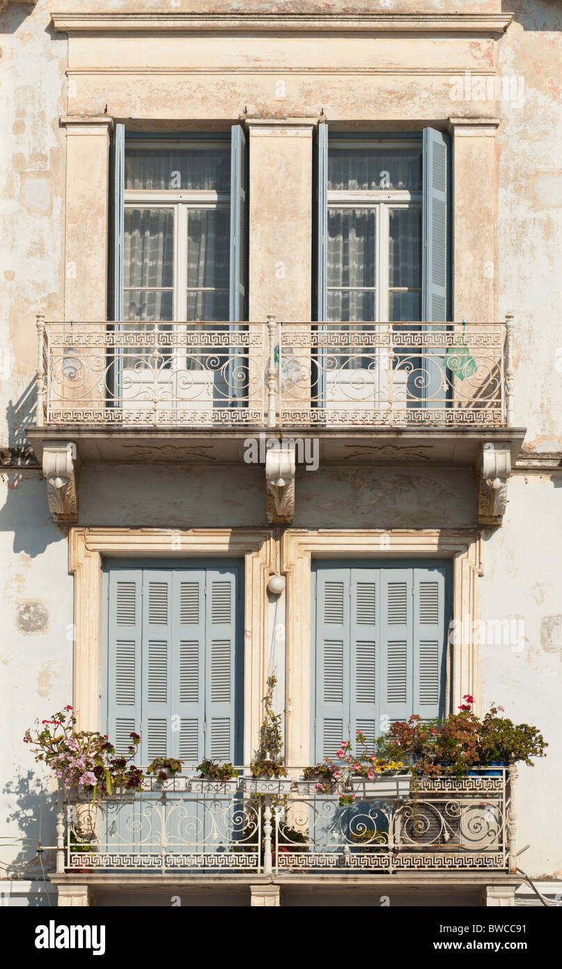 Faded neo-classical building facade in Poros Town, Poros Island, Greece Stock Photo