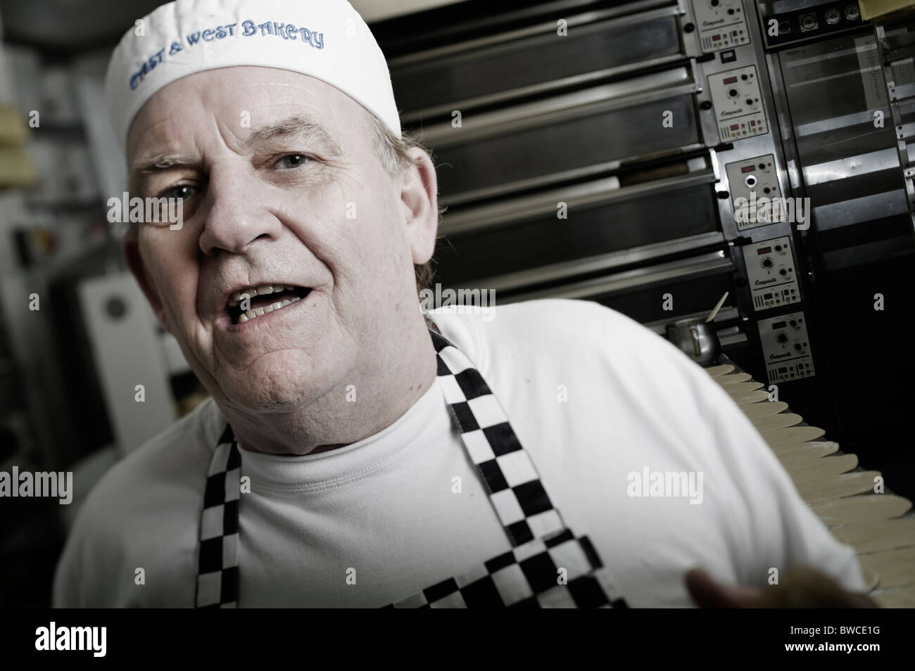 Traditional bakery baker Graham Principe in kitchen, East and West