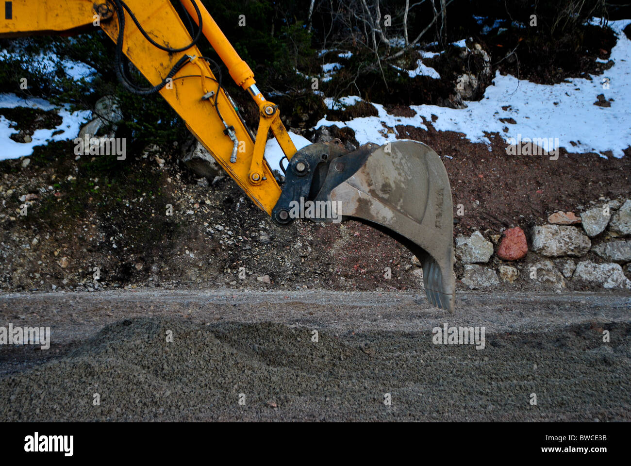 yellow excavator for road work Stock Photo