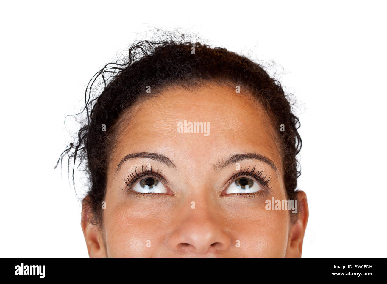 Close-up macro of a happy woman looking up. Isolated on white background. Stock Photo
