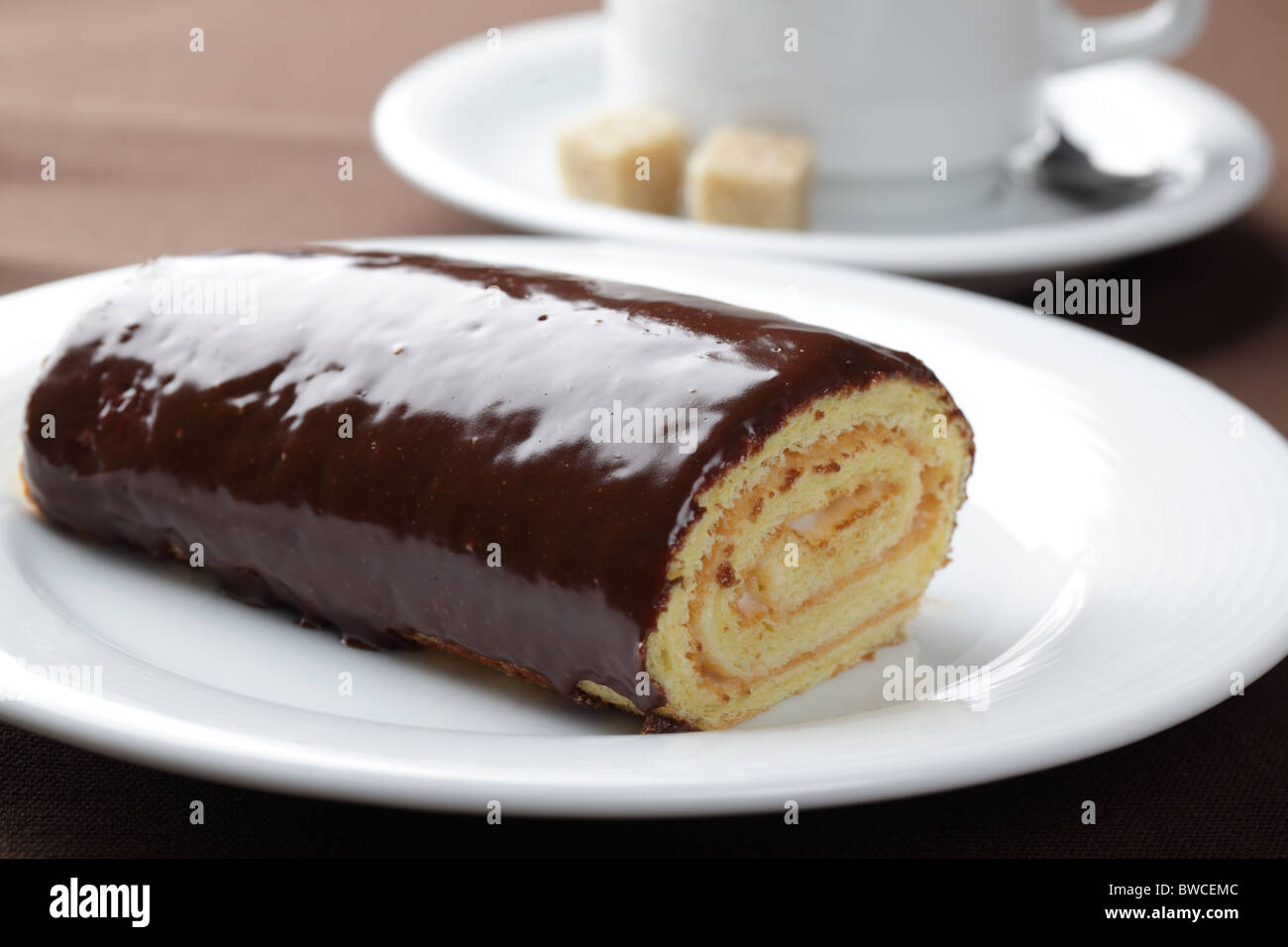 Swiss roll with cream filling and chocolate topping Stock Photo