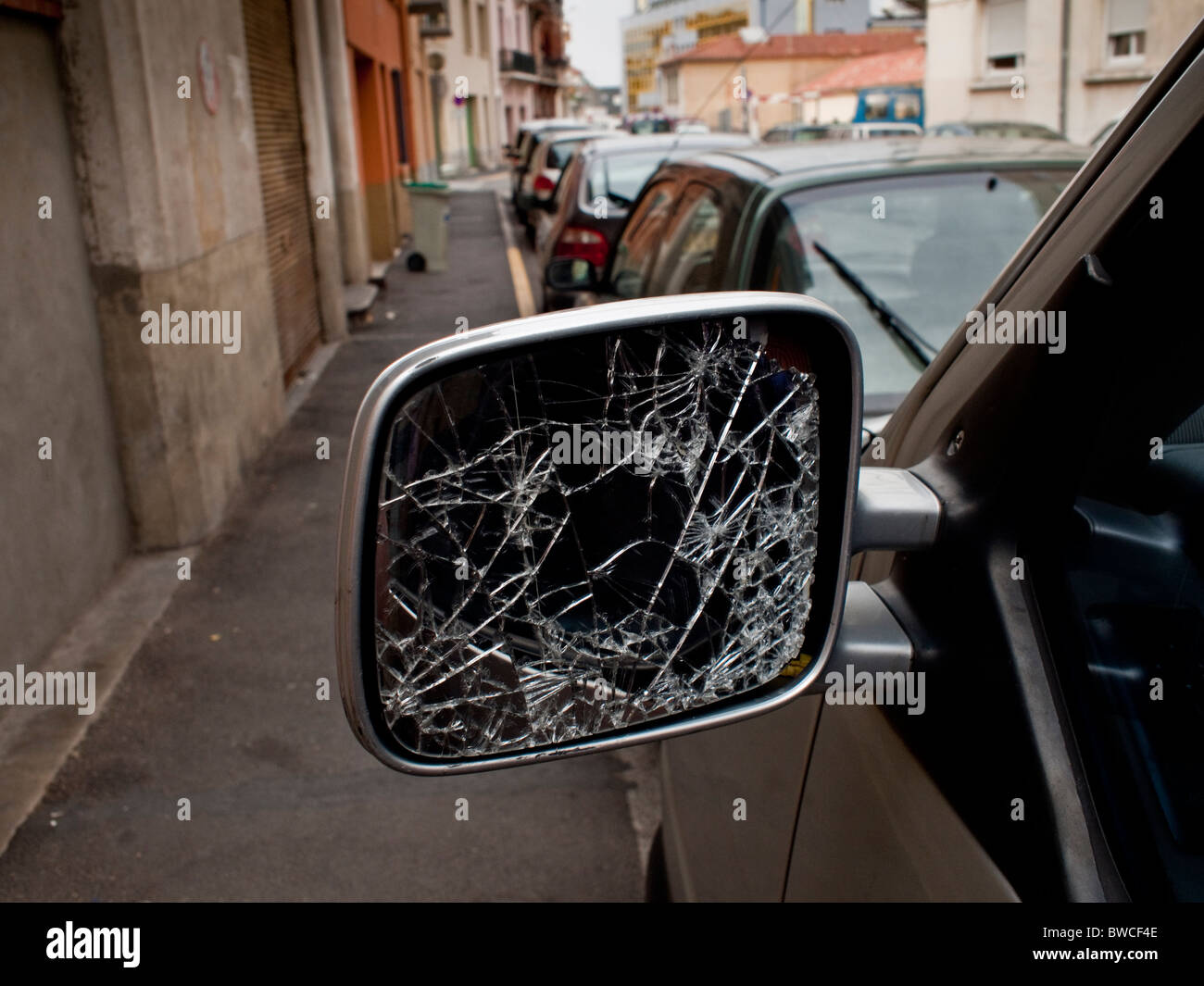 a broken rear view mirror on a street in Perpignan southwest France Stock Photo