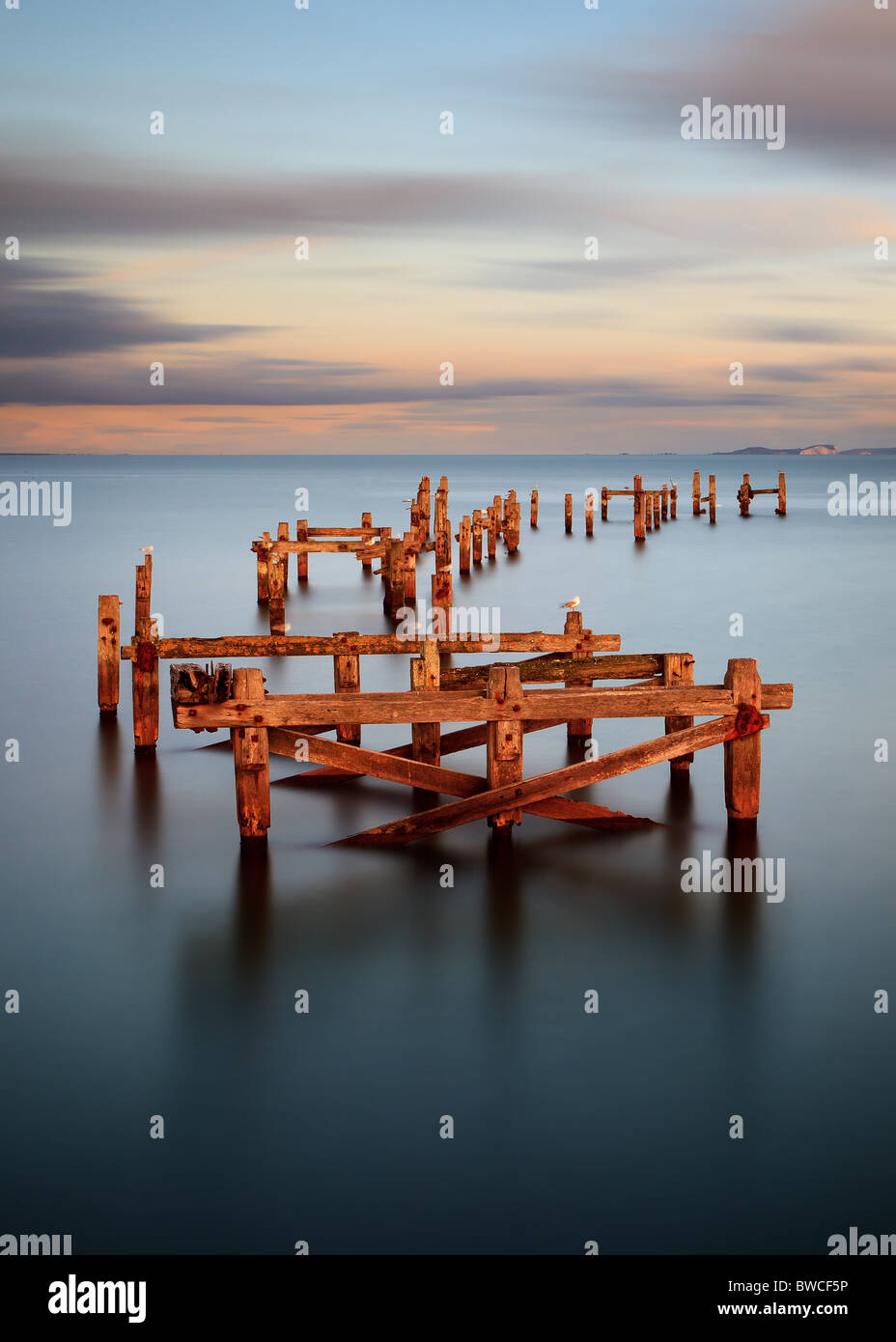 A long exposure image of the old pier in Swanage. Taken during an Autumn sunset. Stock Photo