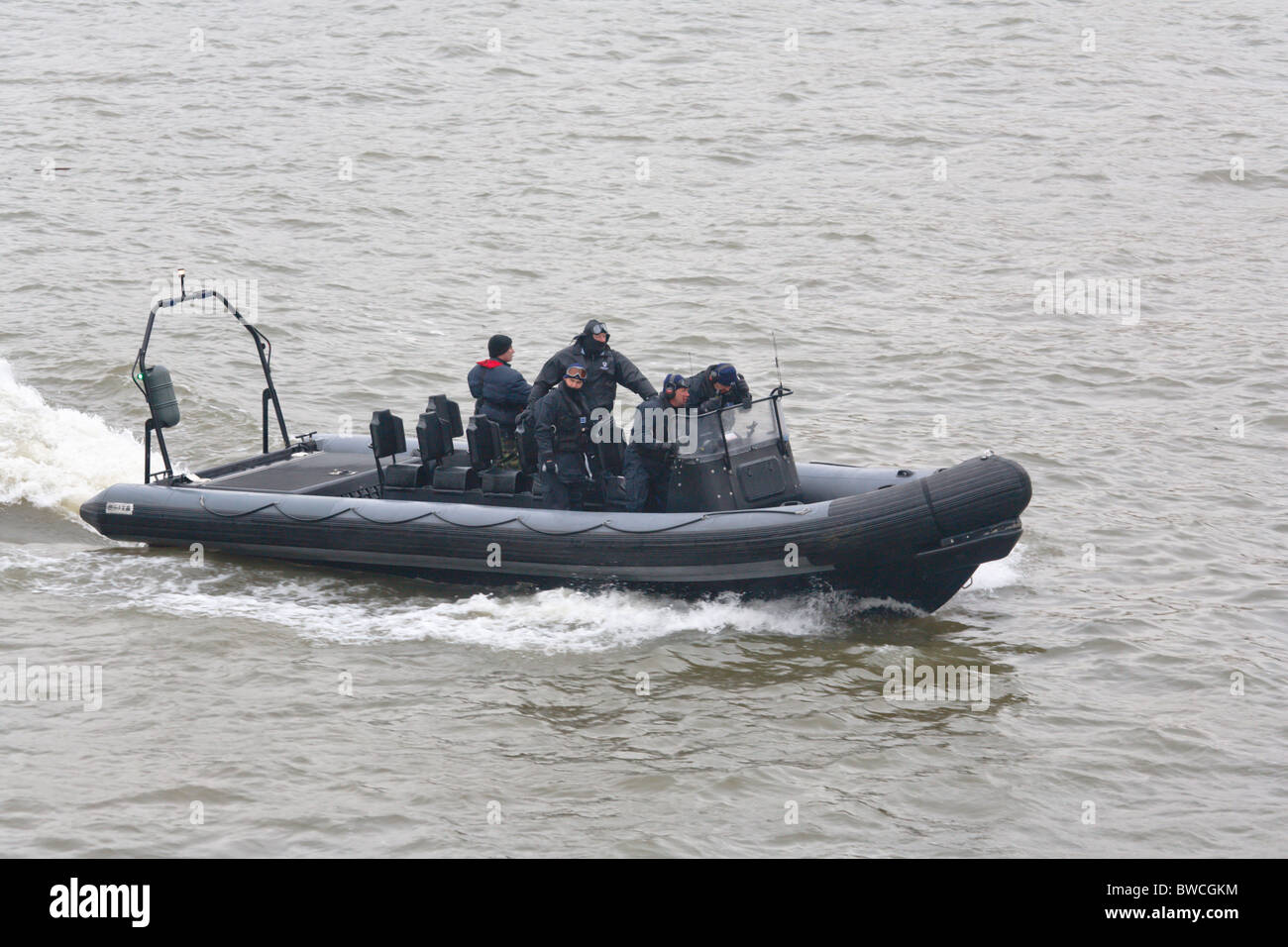 Black clad police in RIB on the river Thames Stock Photo - Alamy