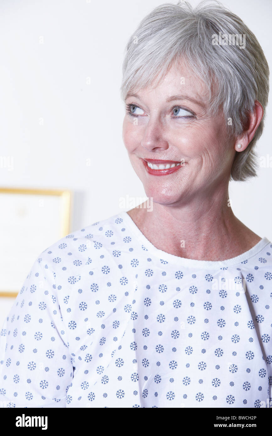 USA, California, Fairfax, Smiling woman in hospital gown sitting in