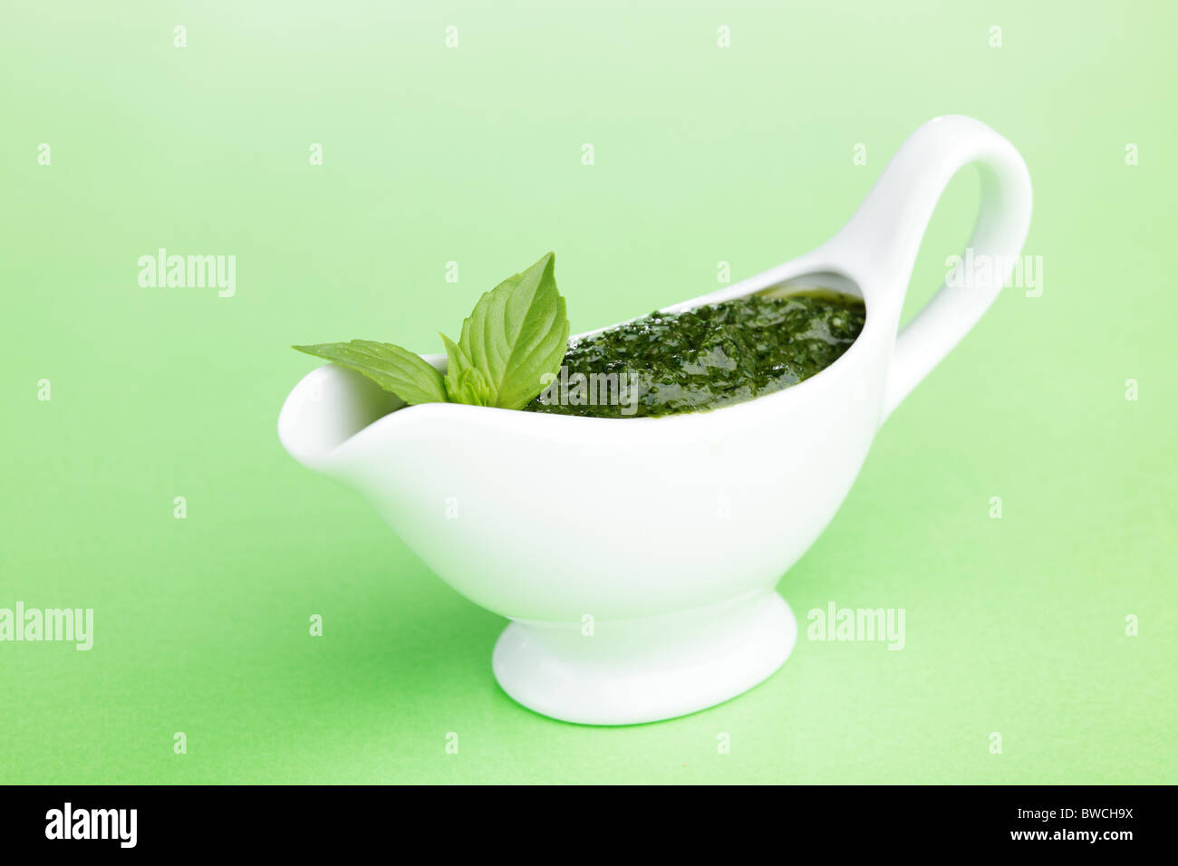 Pesto sauce in white sauce boat Stock Photo