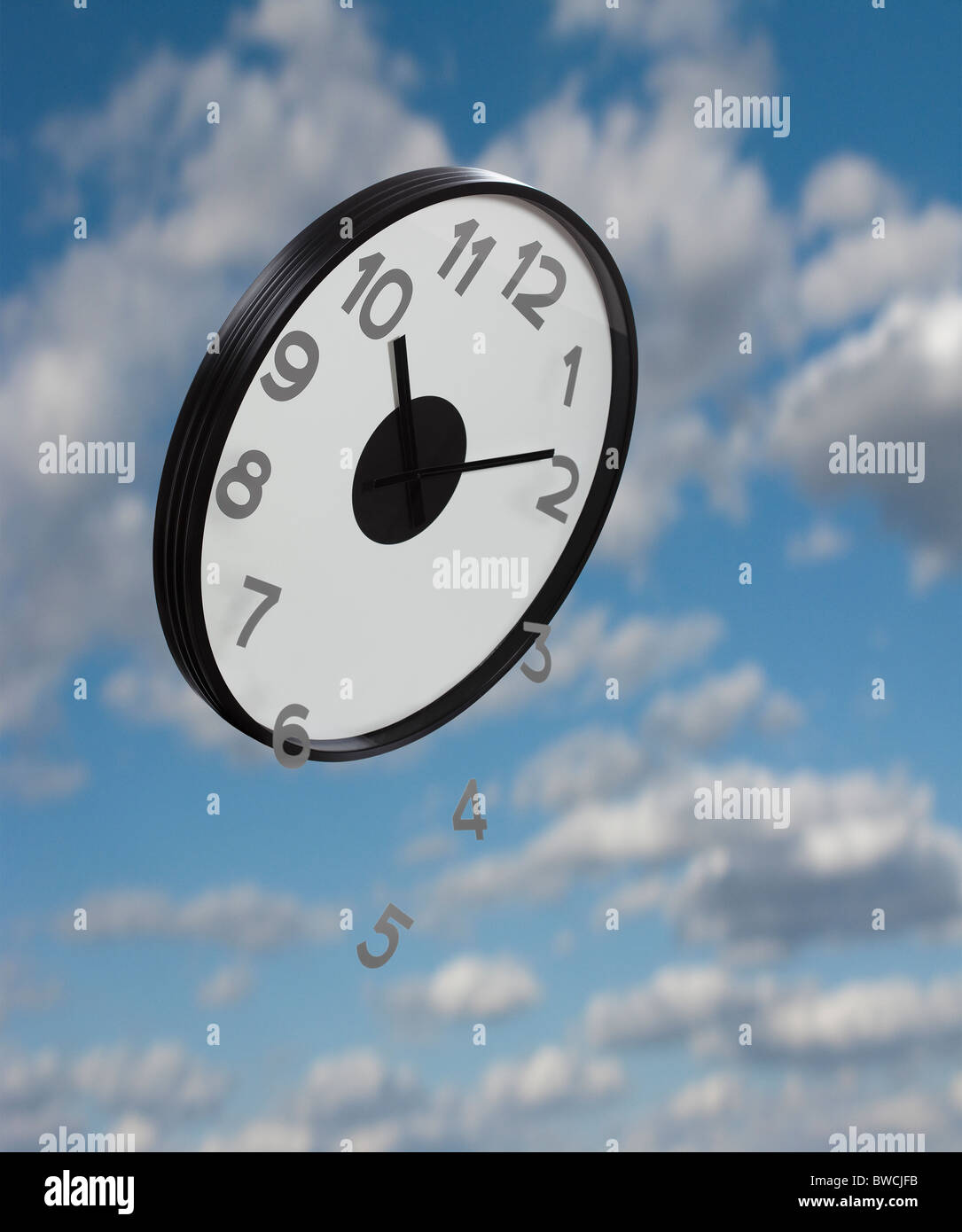 Numbers falling from clock flying against sky, digital composite Stock Photo