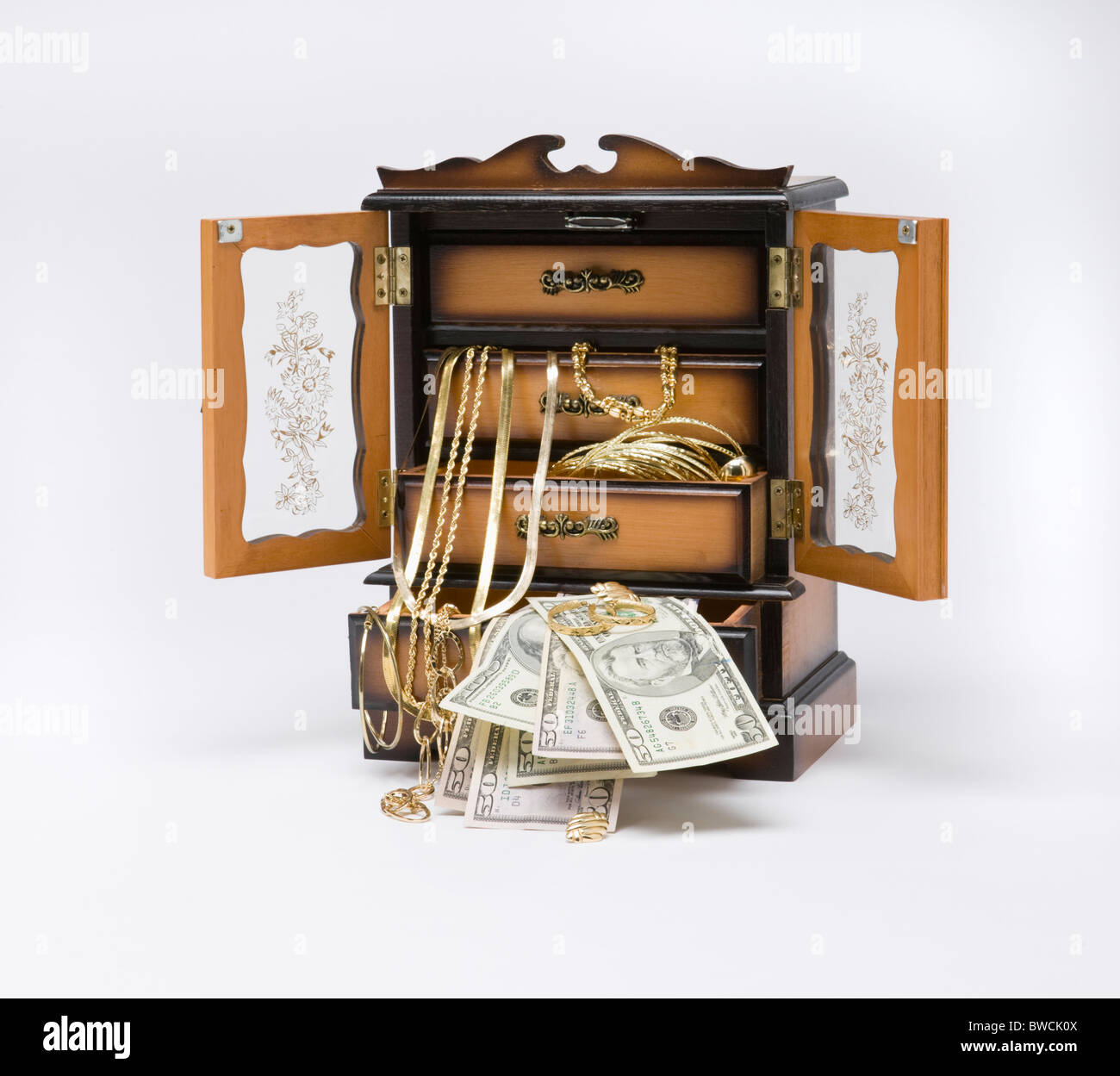 Studio shot of Jewelry box filled with jewelry and money Stock Photo
