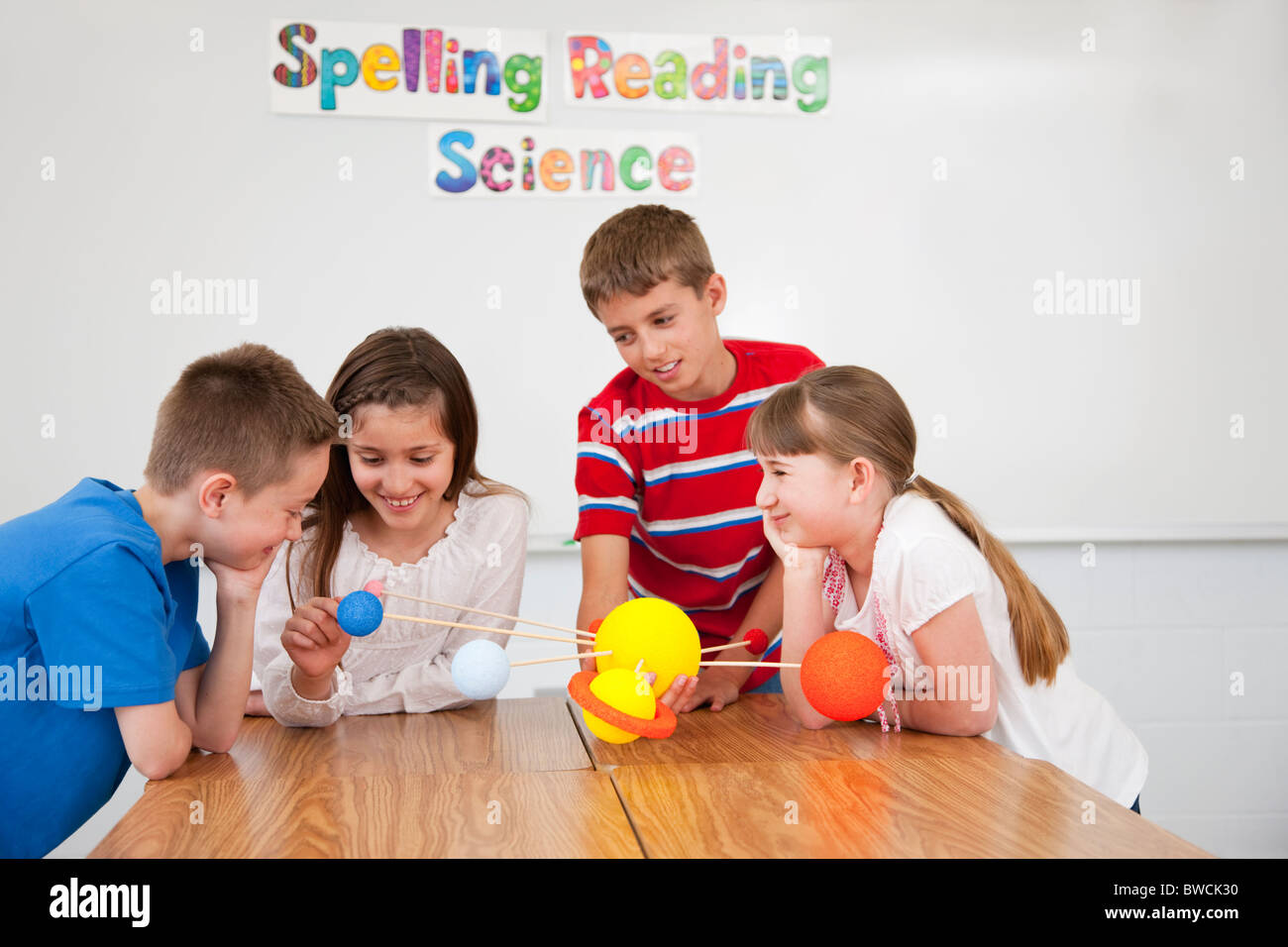 USA, Illinois, Metamora, Schoolchildren (8-9, 10-11) with solar system model at science class Stock Photo
